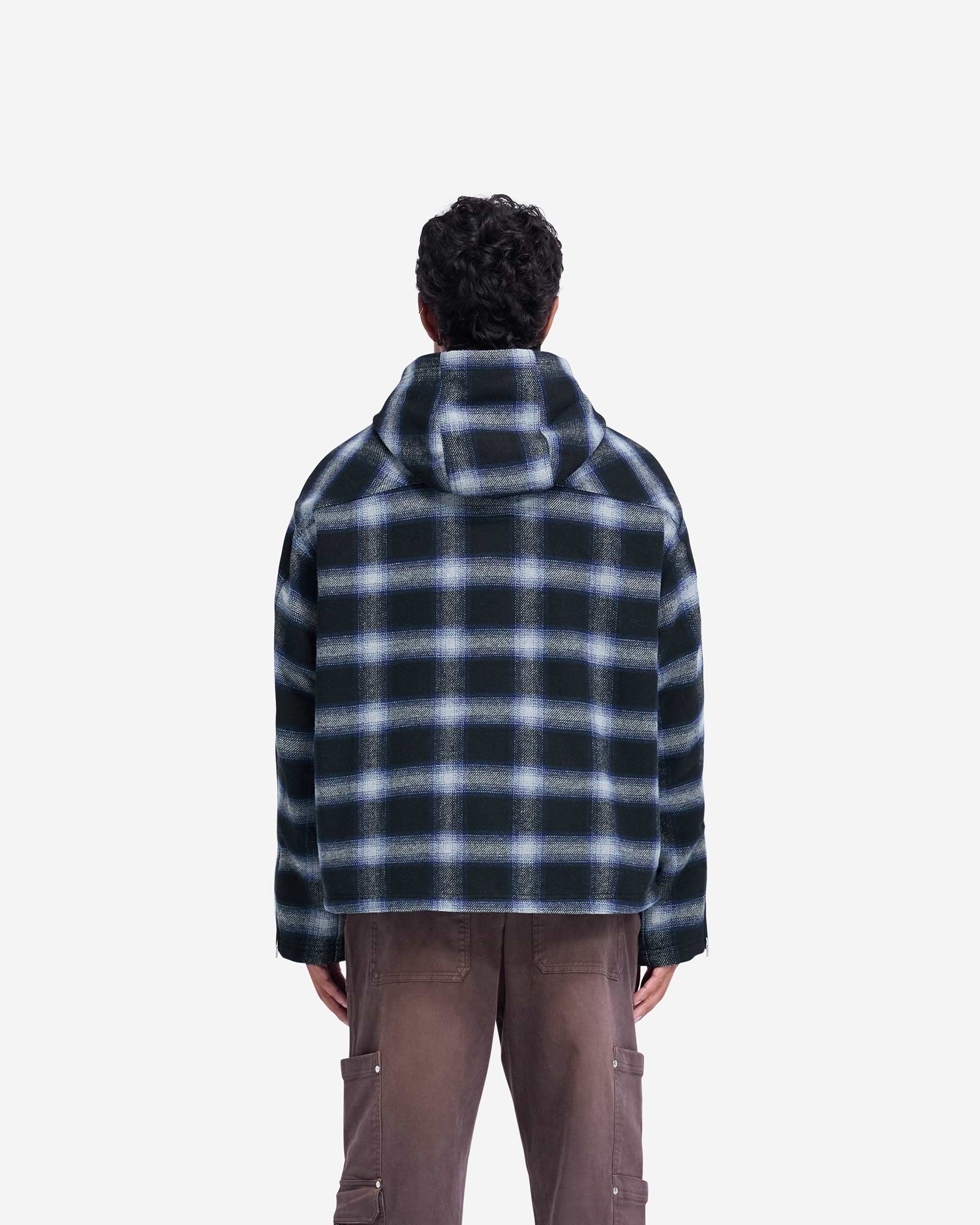Man wearing a navy shirt on a plain white background | Hooded Overshirt in Midnight Navy | Oversized fit with flap pockets and hood | FW24 Shirts | Represent Clo