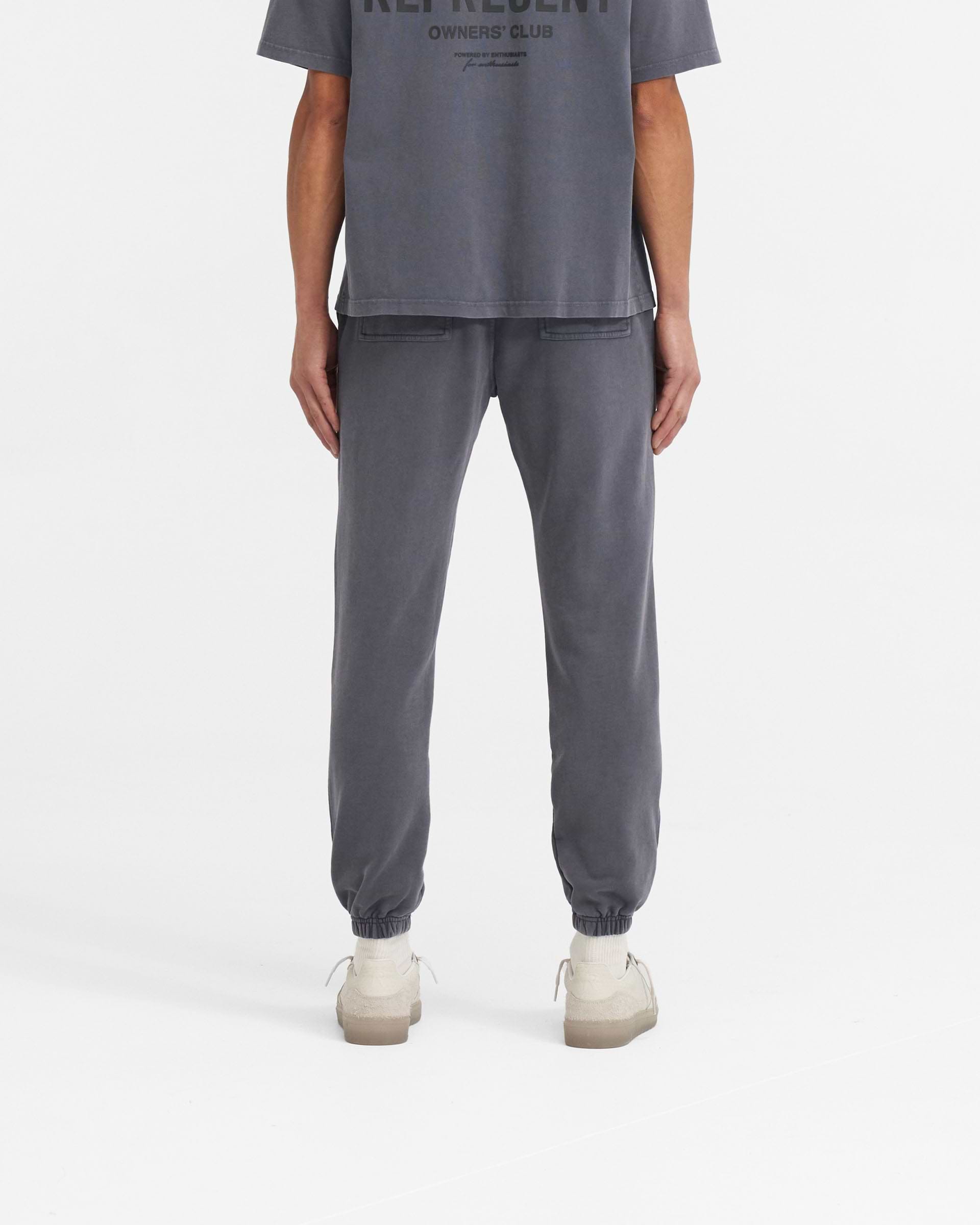 Man wearing grey sweatpants on a plain white background | Represent Owners Club Sweatpant in Storm | Sweatpants with elasticated waistband and cuffs | Owners Club Pants | Represent Clo