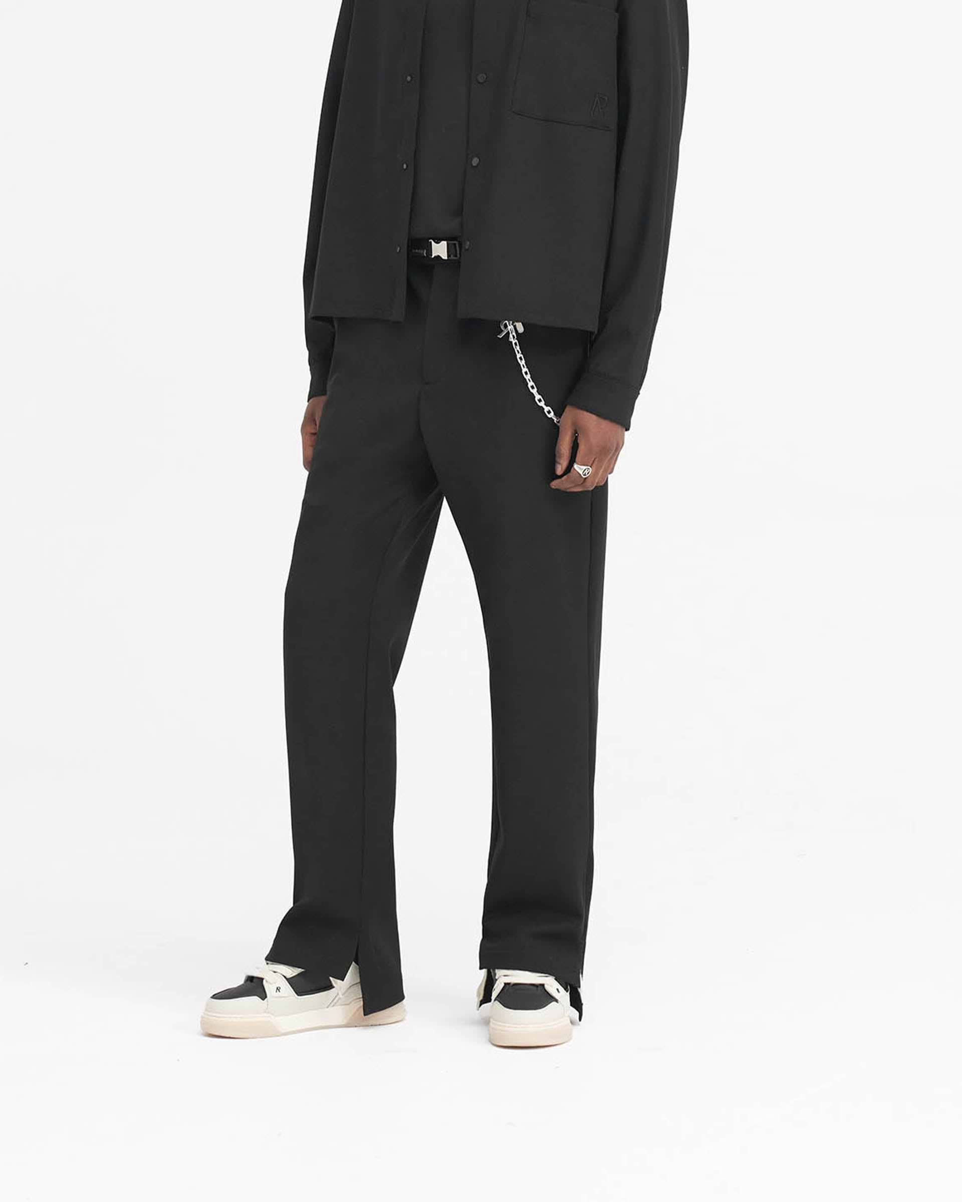 Back product image of mens black wide leg pants on a plain white background | Stepped Hem Pant in Black | Pants with split hem and twill finish | SS24 Pants | Represent Clo