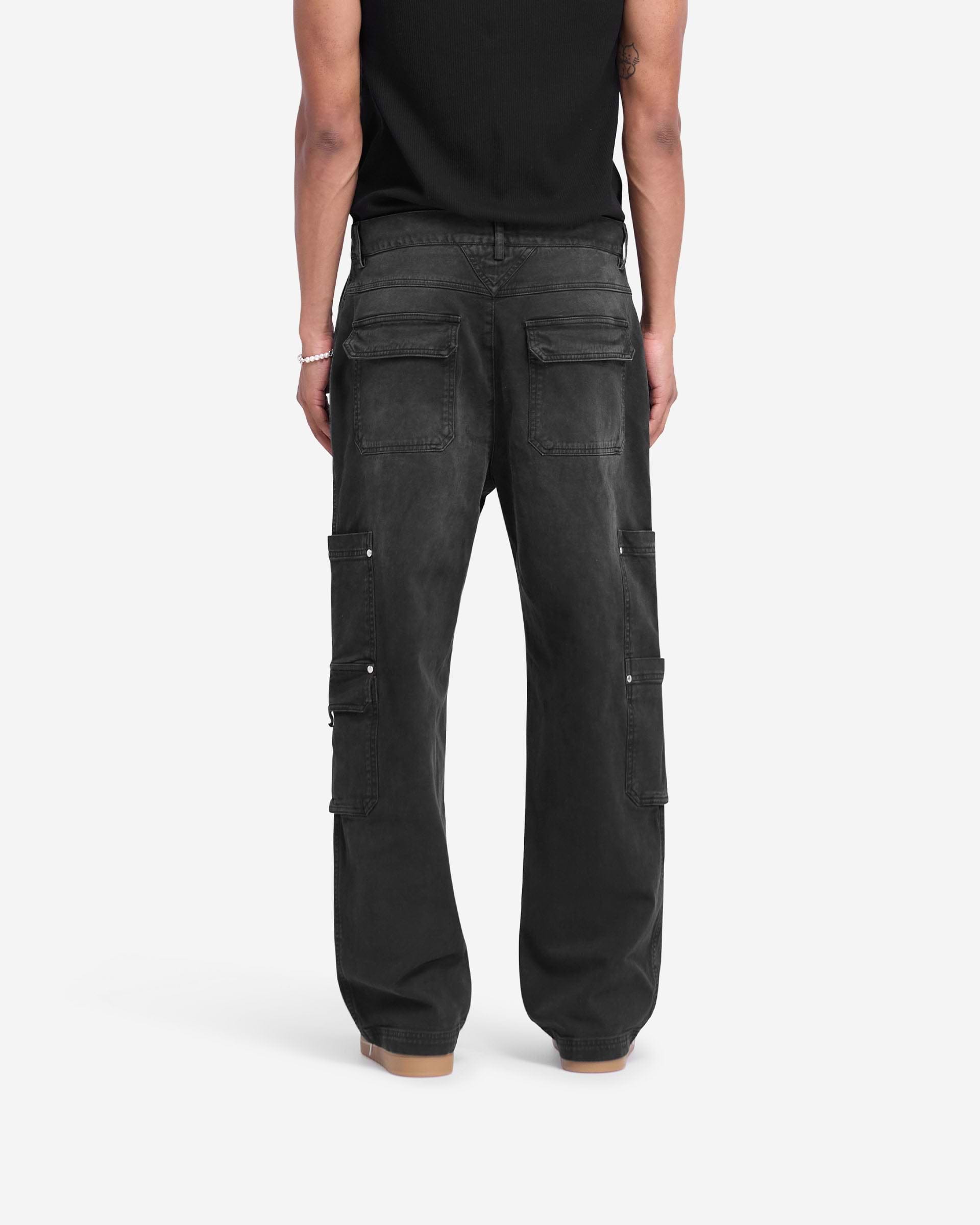 Man wearing washed black pants on a plain white background | Workshop Pant in Washed Black | Relaxed straight fit pants with 3D cargo pockets | FW24 Pants | Represent Clo