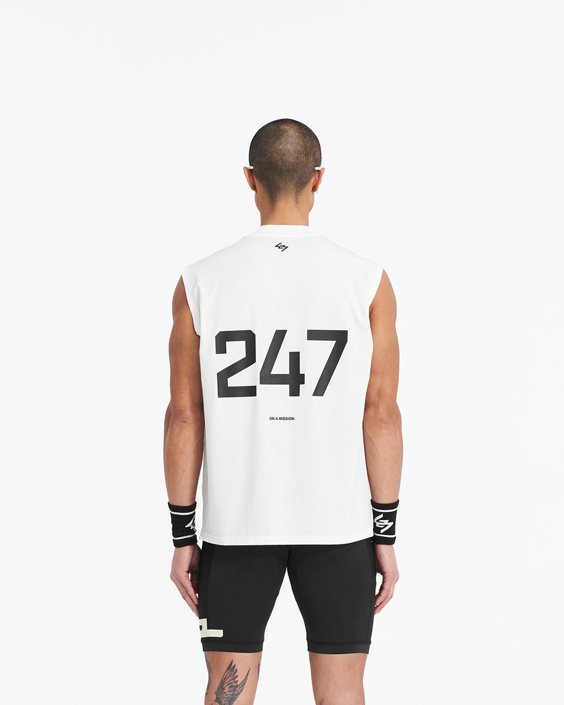 Man wearing an oversized white tank top on a plain white background | 247 Oversized Tank in Flat White | Lightweight and breathable tank with 4-way stretch | 247 T-Shirts | Represent Clo