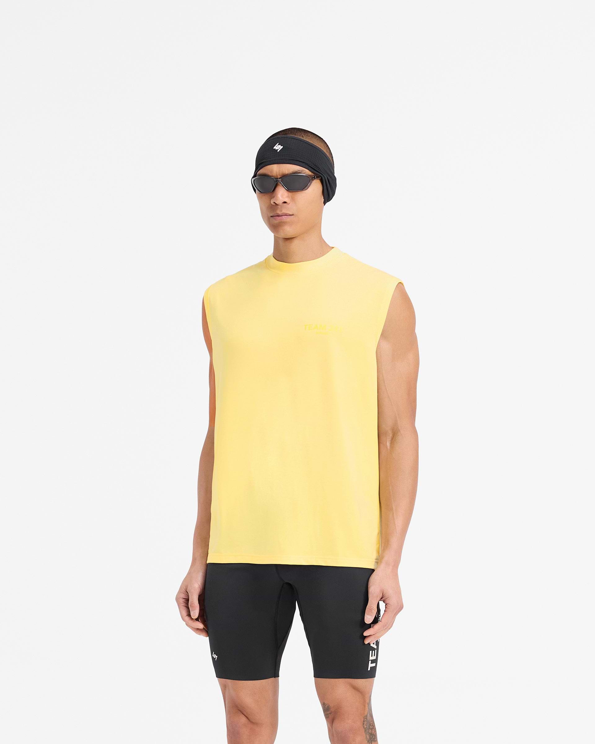 Man wearing a yellow oversized tank on a plain white background | Team 247 Oversized Tank in Lemon | Quick drying training tank top | 247 T-Shirts | Represent Clo