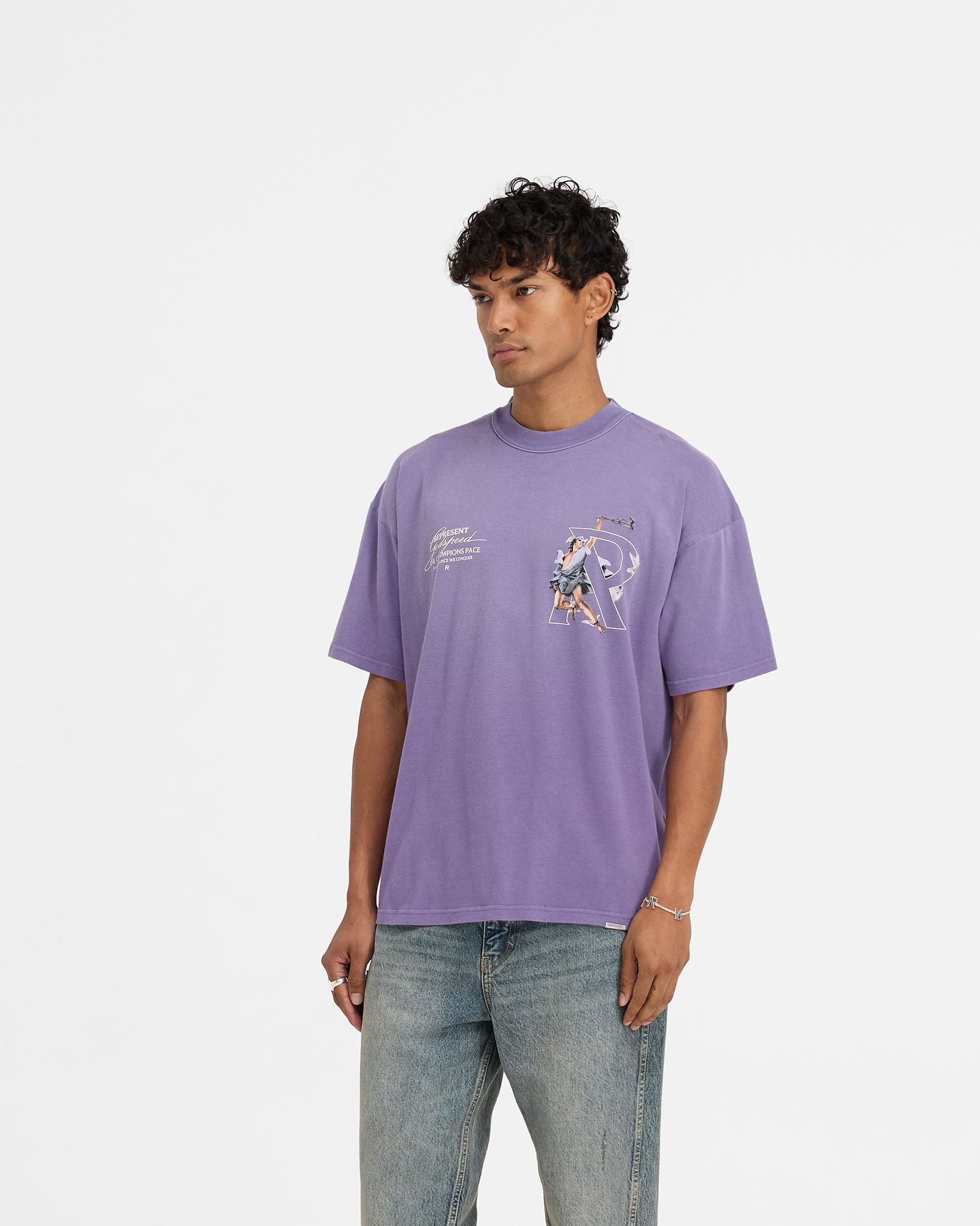 Man wearing a purple t-shirt on a plain white background | Hermes T-Shirt in Purple | Oversized t-shirt with high density screen print graphic | FW24 T-Shirts | Represent Clo