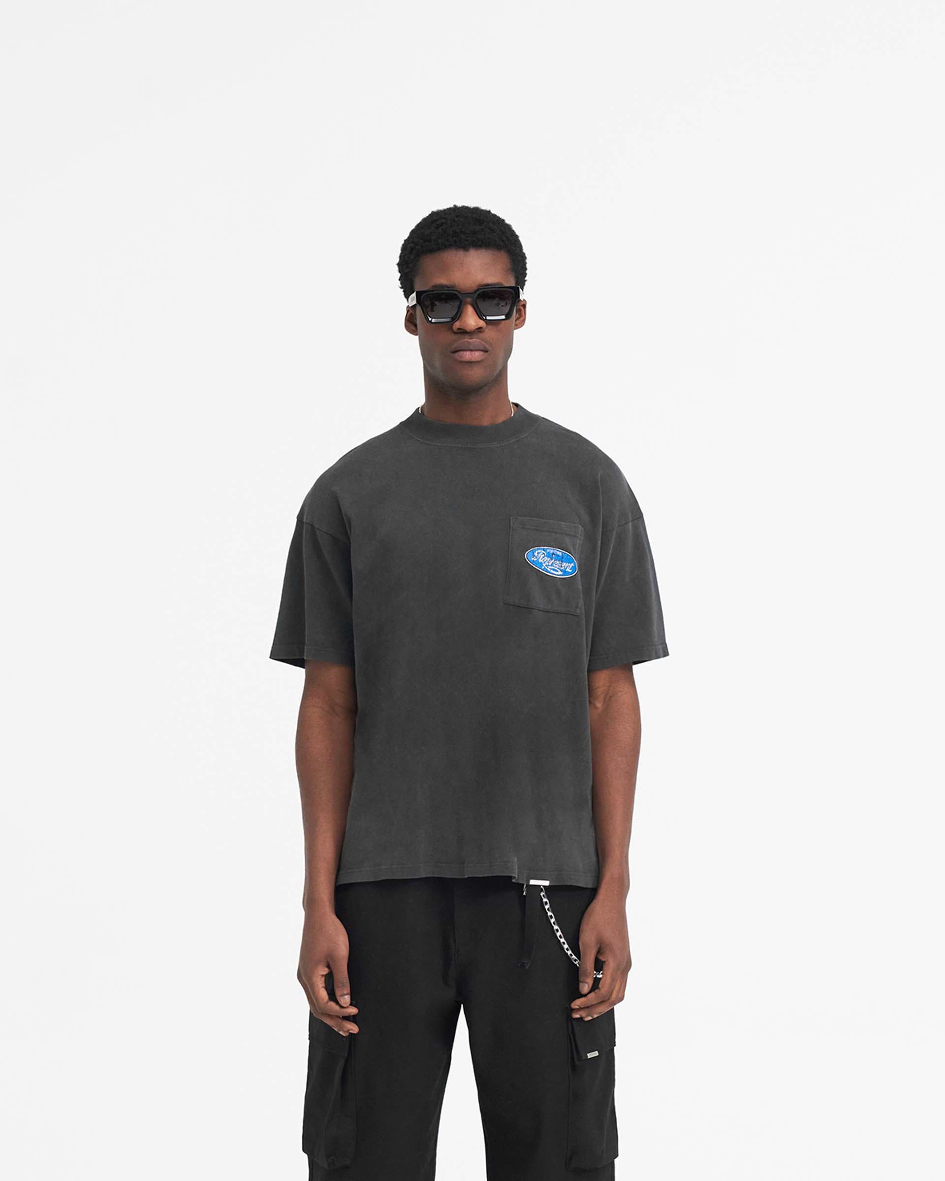 Man wearing an aged black t-shirt on a plain white background | Classic Parts T-Shirt in Aged Black | Oversized t-shirt with cracked Horizons graphic | SS24 T-Shirts | Represent Clo