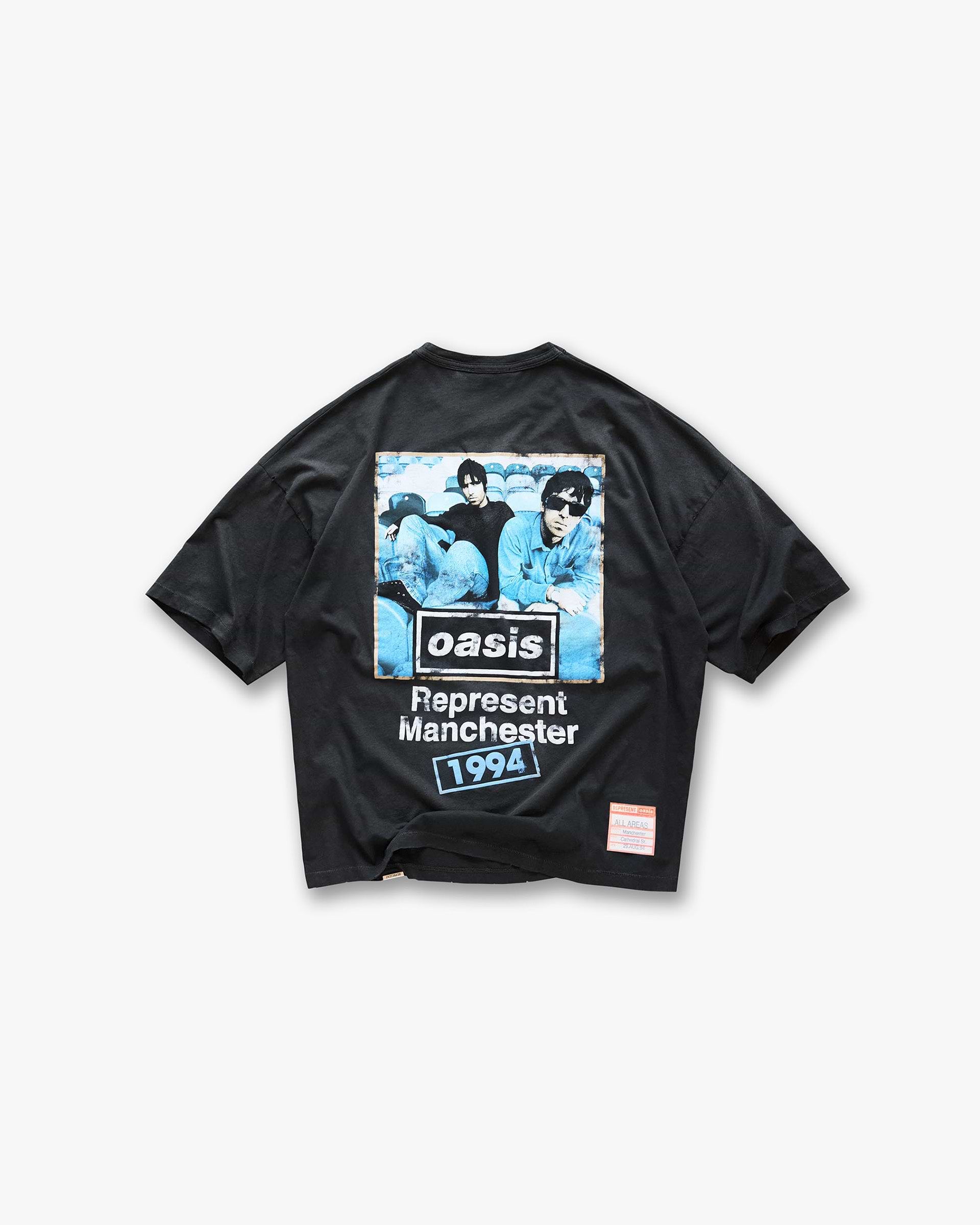 Back product image of a mens black t-shirt on a plain white background | Represent X Oasis Maine Road T-Shirt in Washed Black | Oversized boxy fit t-shirt with distressed details | FW24 T-Shirts | Represent Clo