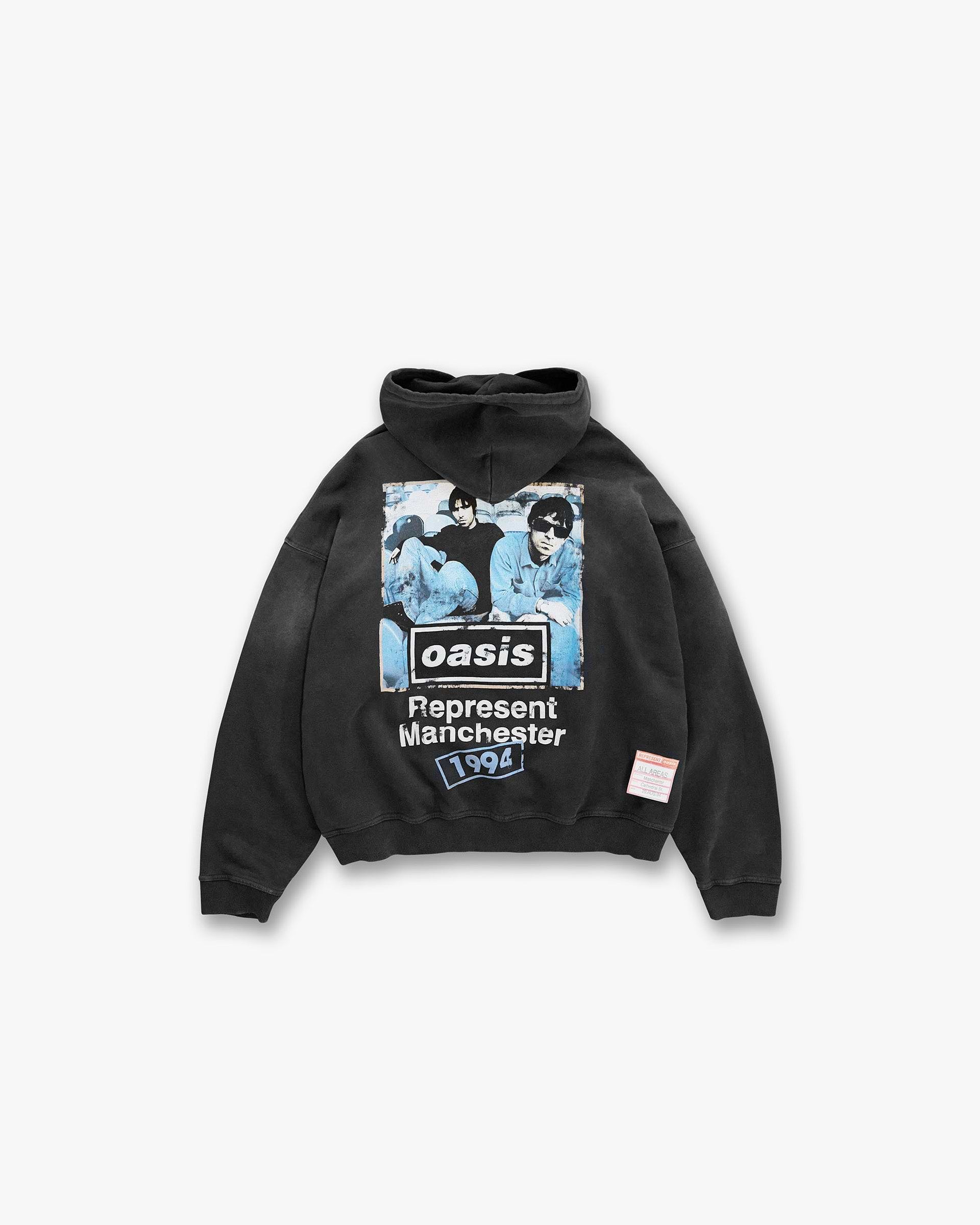 Back product image of a mens black hoodie on a plain white background | Represent X Oasis Maine Road Hoodie in Washed Black | Hoodie with iconic Oasis imagery and distressed details | FW24 Hoodies | Represent Clo