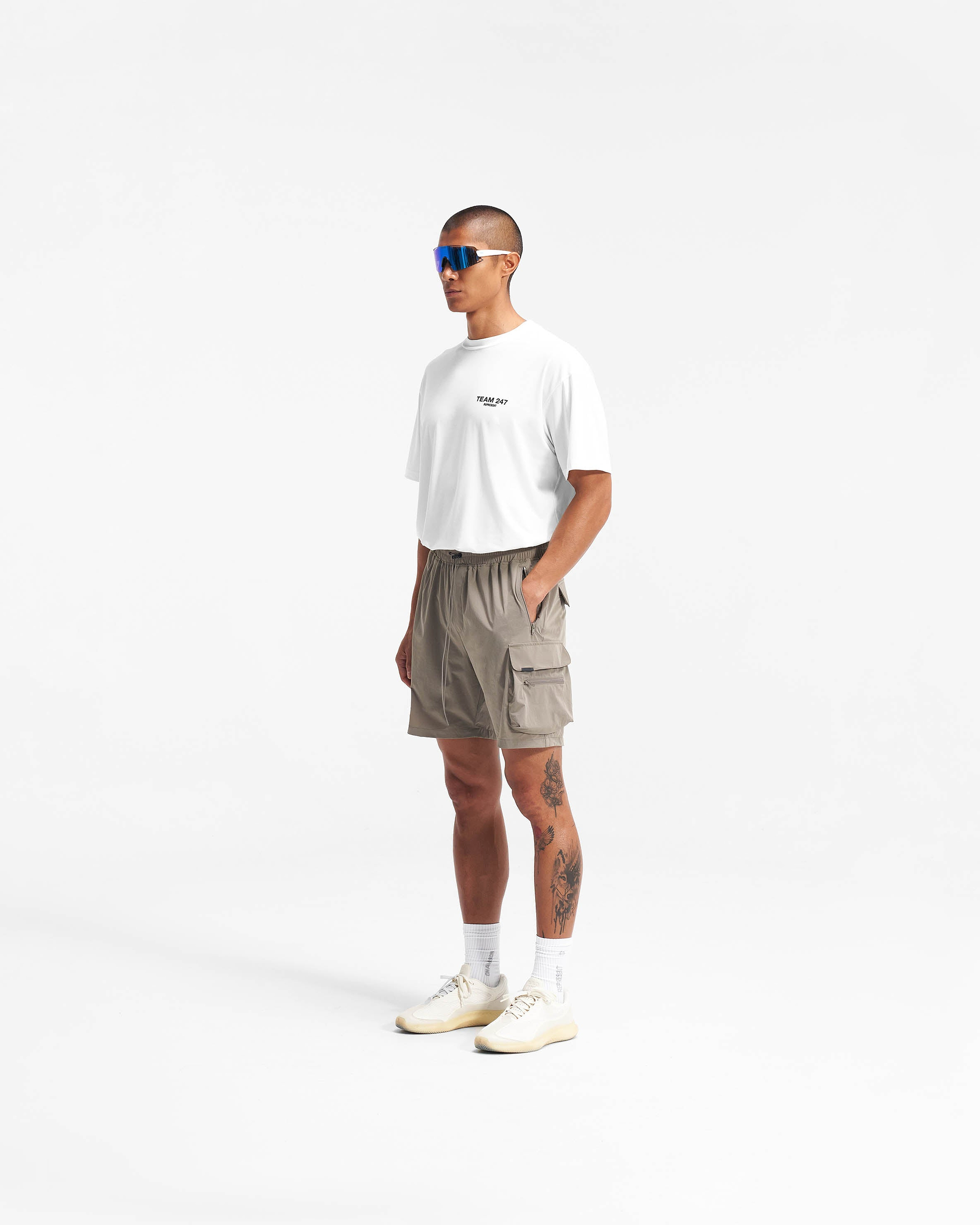 Back product image of mens taupe shorts on a plain white background | 247 Shorts in Taupe | Combat shorts with cargo leg pockets and zip side pockets | 247 Shorts | Represent Clo