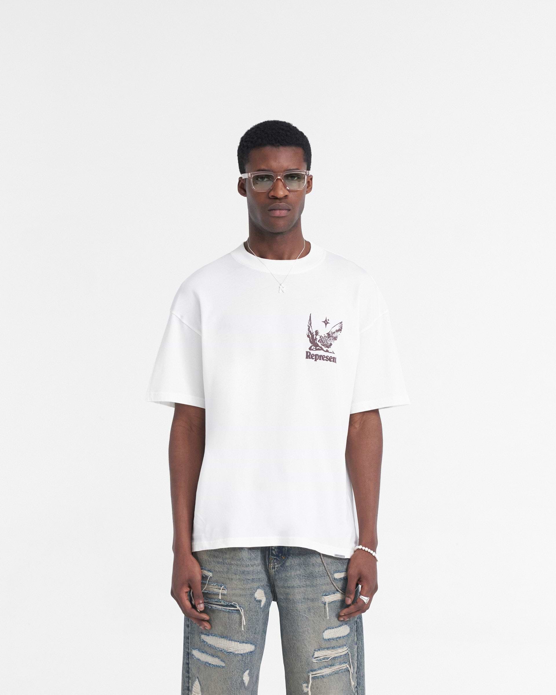 Man wearing a white t-shirt on a plain white background | Spirits Of Summer T-Shirt in Flat White | Oversized t-shirt with puff print graphic and metal bar | SS24 T-Shirts | Represent Clo