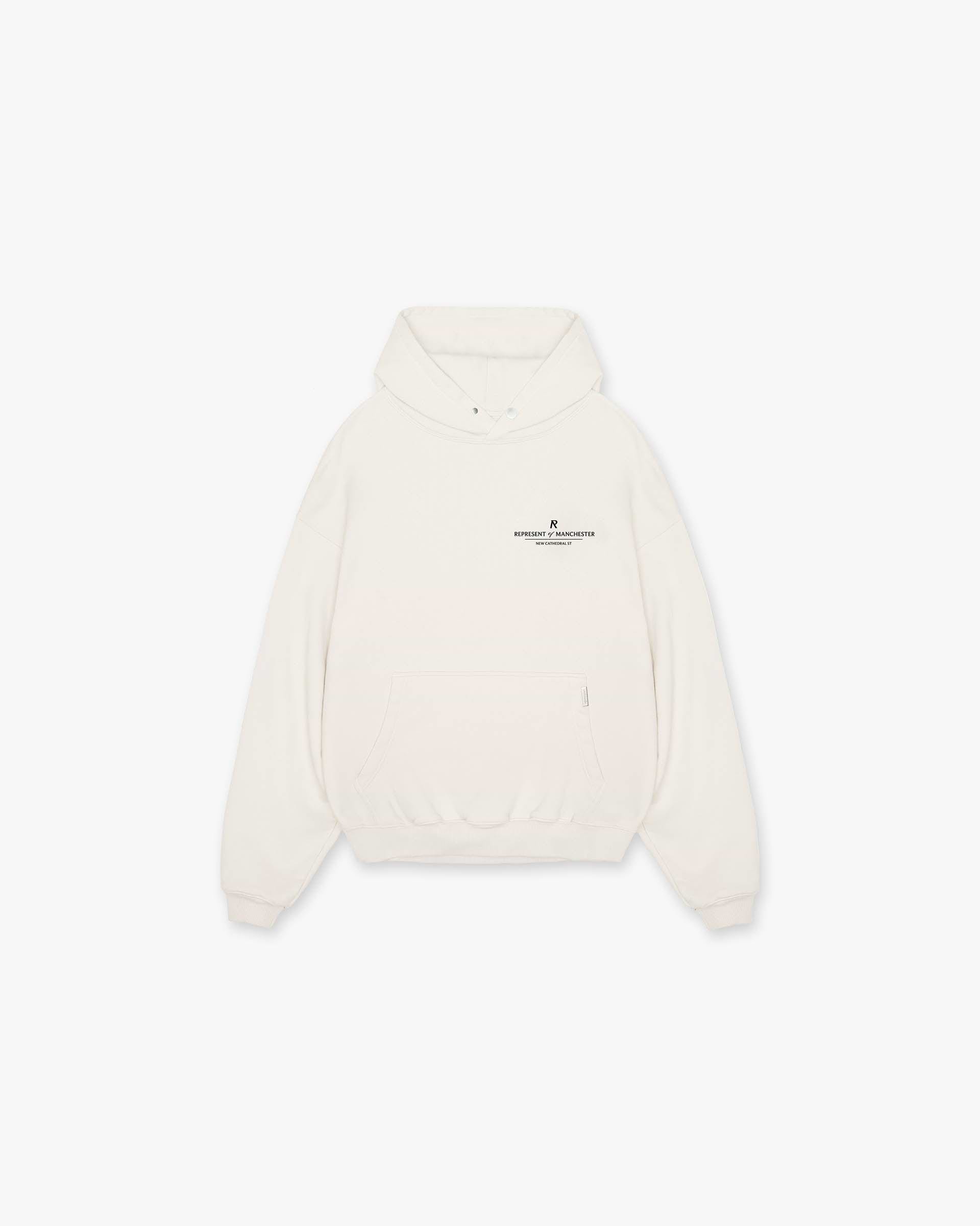 Front product image of a mens white hoodie on a plain white background | Manchester Store Hoodie in Flat White | Classic hoodie with subtle branding | Exclusives Hoodies | Represent Clo