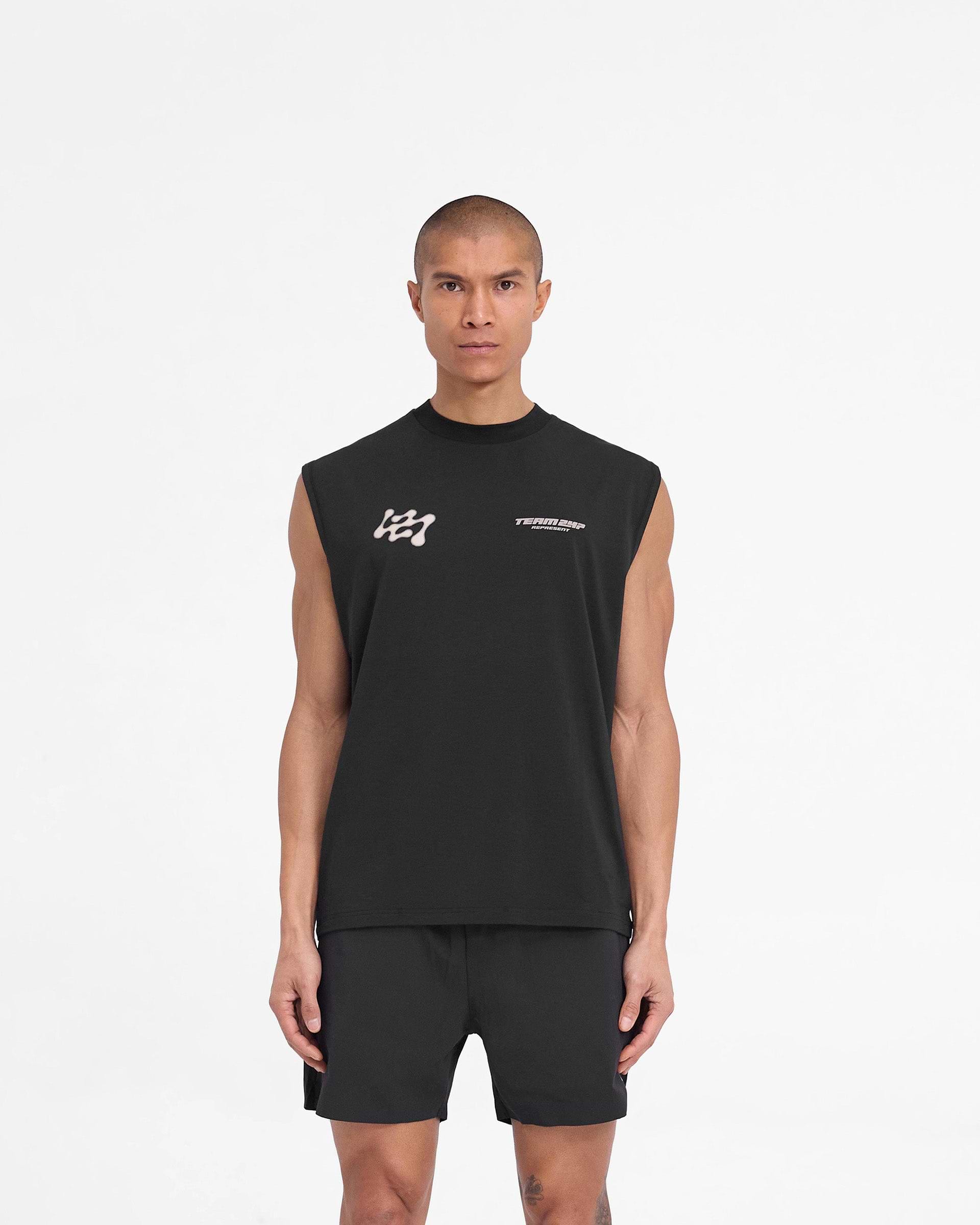Man wearing a black tank top on a plain white background | 247 Future Terrains Oversized Tank in Black | Oversized tank top with quick drying and moisture wicking features | 247 T-Shirts | Represent Clo