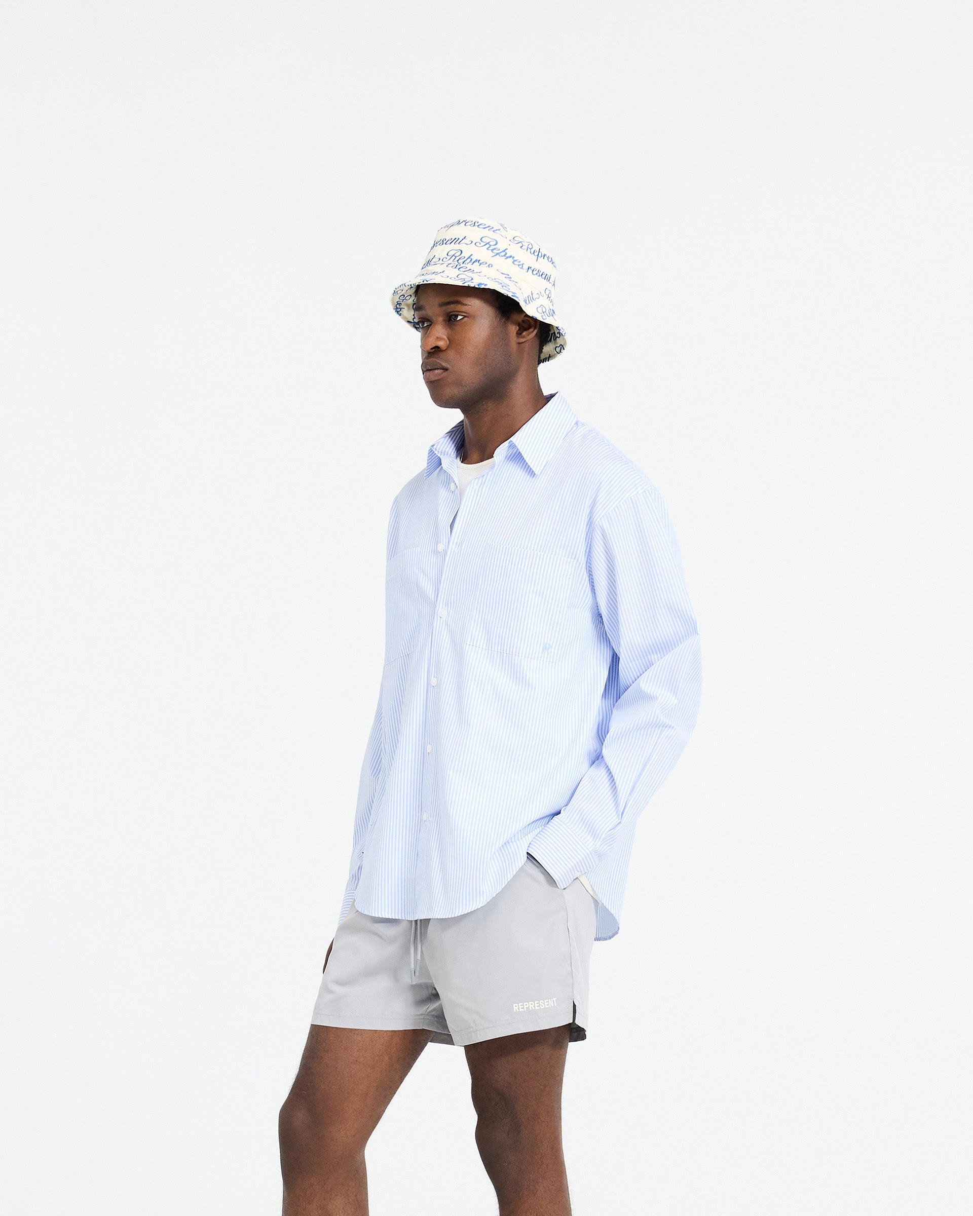 Back product image of a mens blue pinstripe shirt on a plain white background | Long Sleeve Pinstripe Shirt in Baby Blue | Oversized fit shirt with concealed placket and chest pockets | SC24 Shirts | Represent Clo