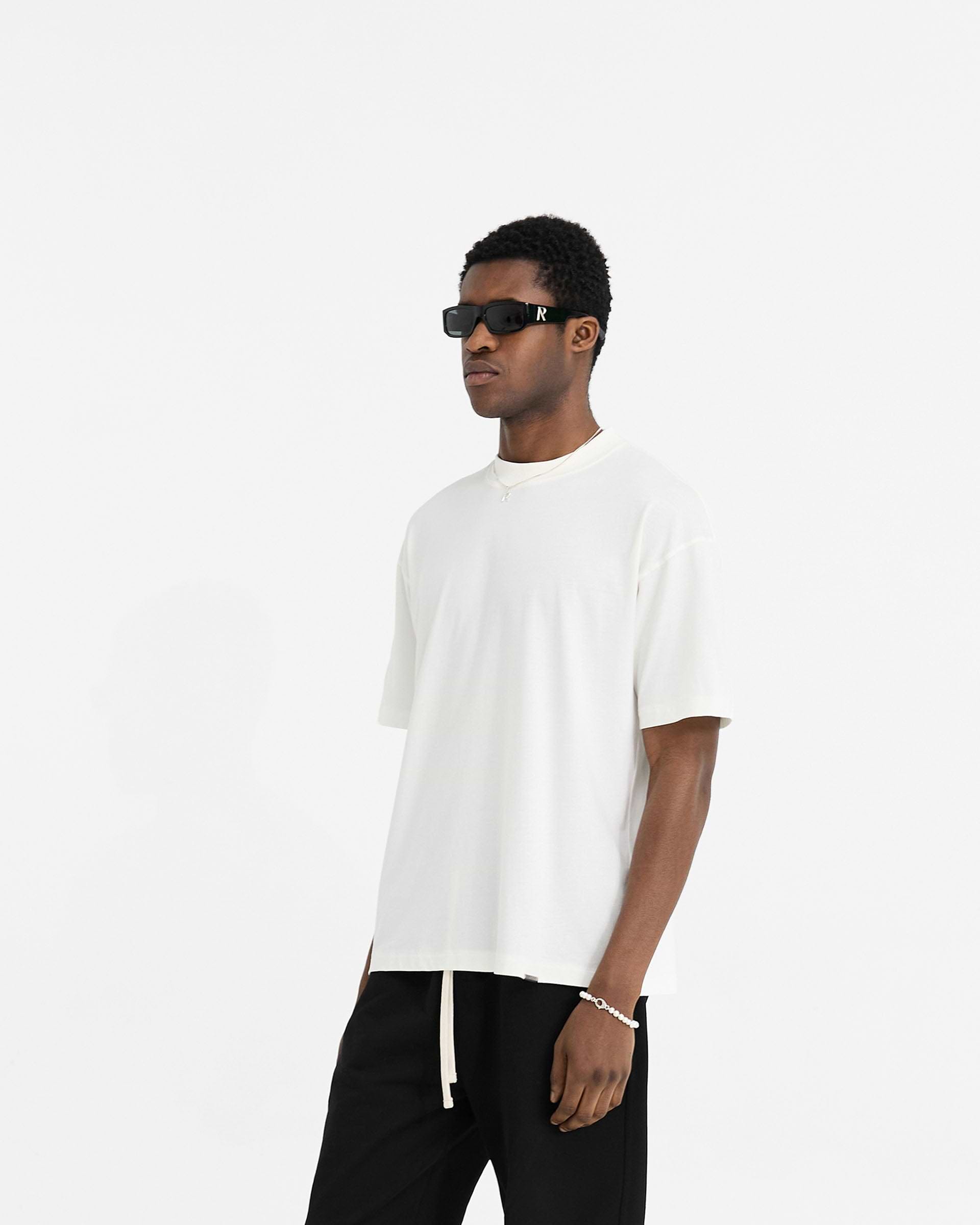 Back product image of a mens white t-shirt on a plain white background | Initial Oversized T-Shirt in Flat White | Oversized t-shirt with embroidered initial | Initial T-Shirts | Represent Clo