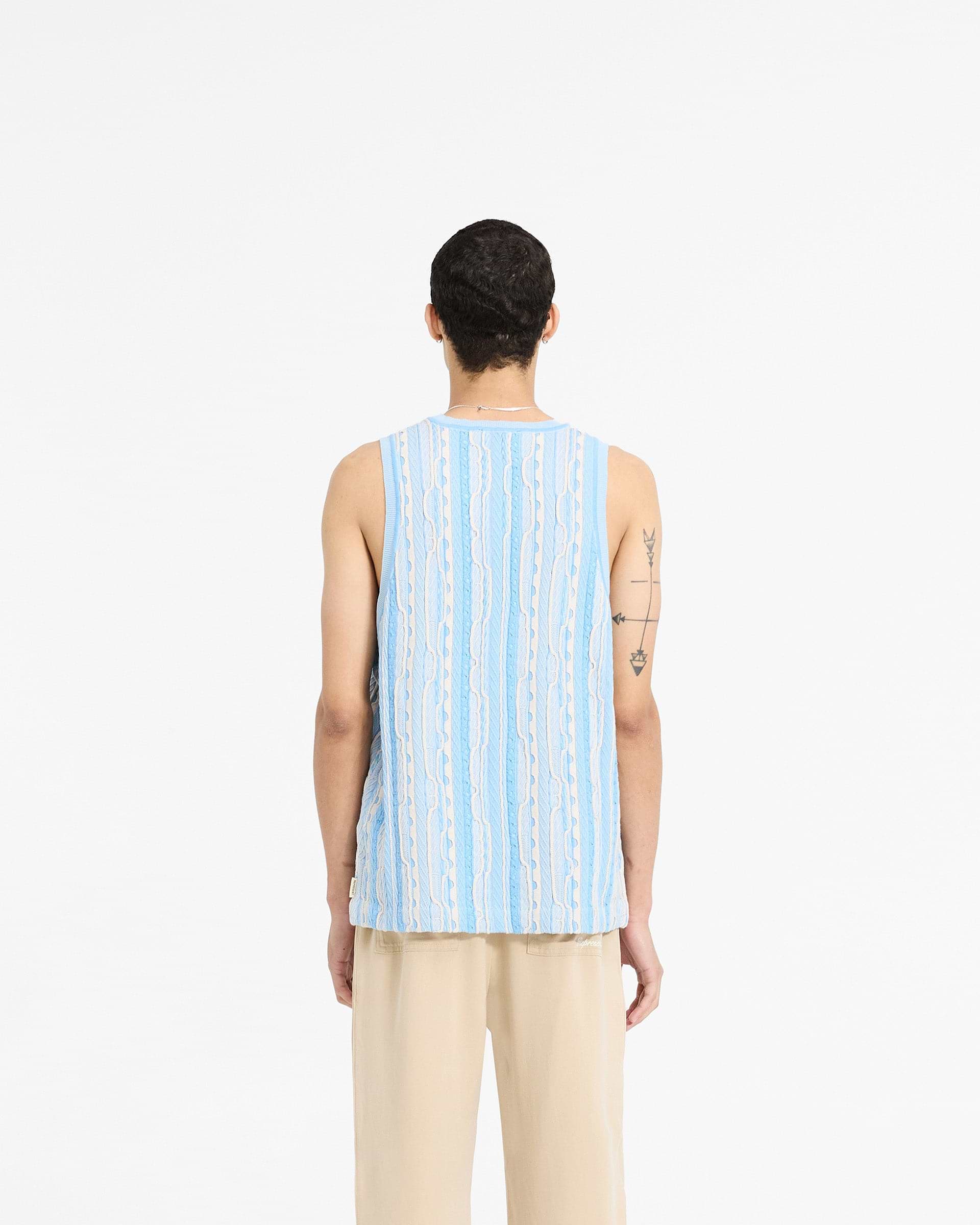 Man wearing a blue knit vest on a plain white background | Mixed Knit Vest in Royal Blue | Regular fit vest with custom knit pattern | SC24 Knitwear | Represent Clo