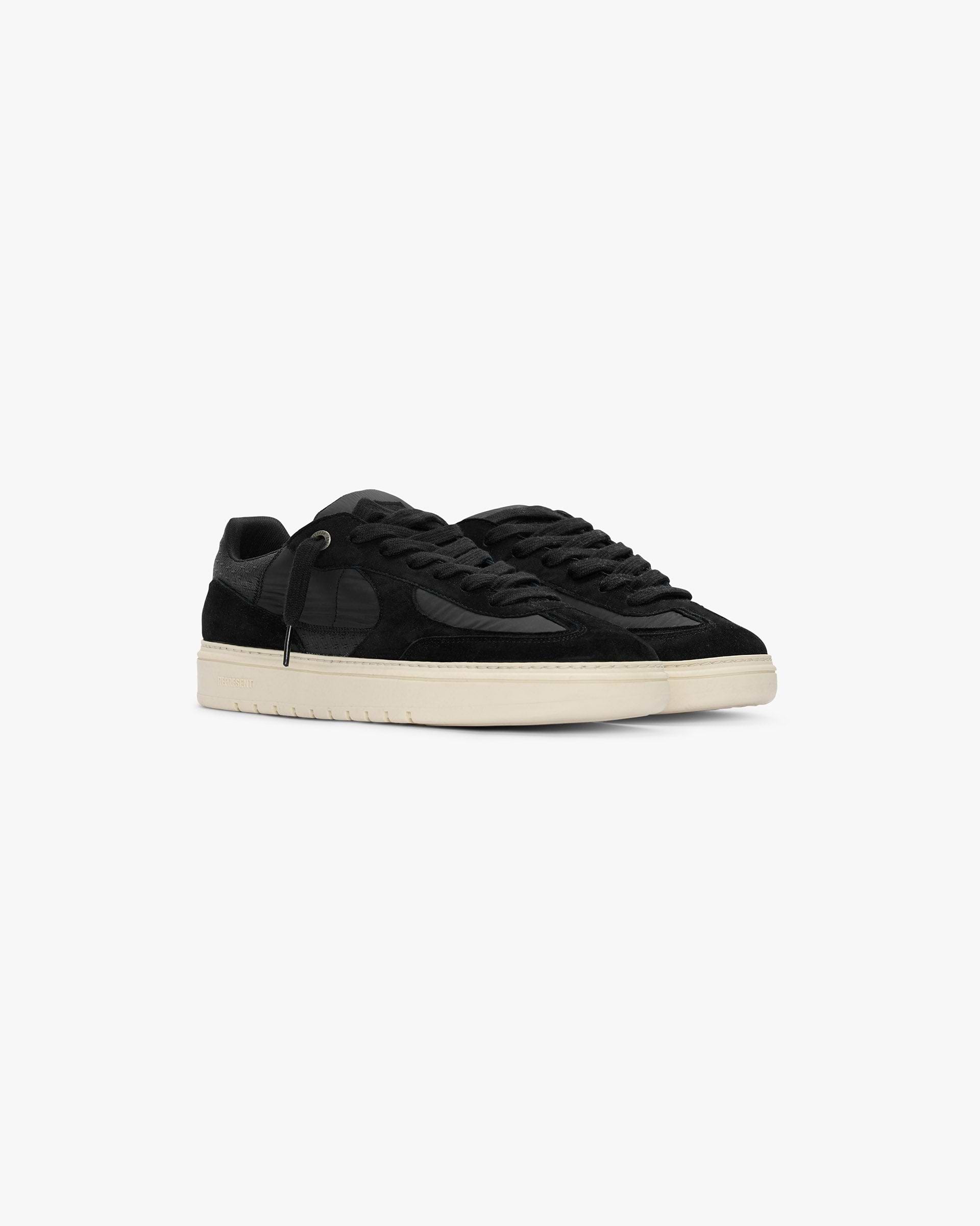 Back product image of a mens black sneaker on a plain white background | Virtus in Off Black | Low profile sneaker with nubuck panelling and zig zag stitch detail | SS25 Footwear | Represent Clo