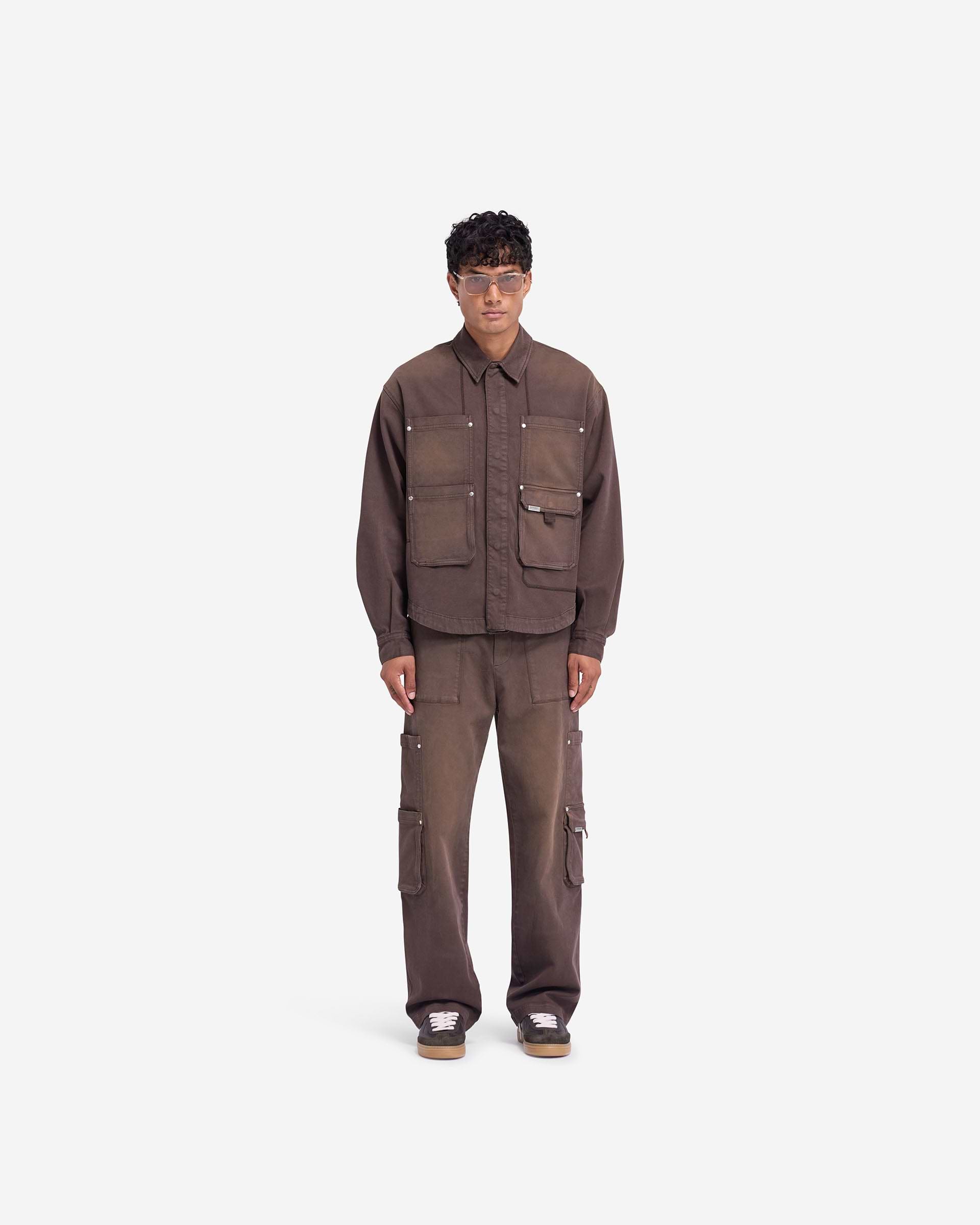Man wearing cedar pants on a plain white background | Workshop Pant in Cedar | Relaxed straight fit pants with 3D cargo pockets | FW24 Pants | Represent Clo