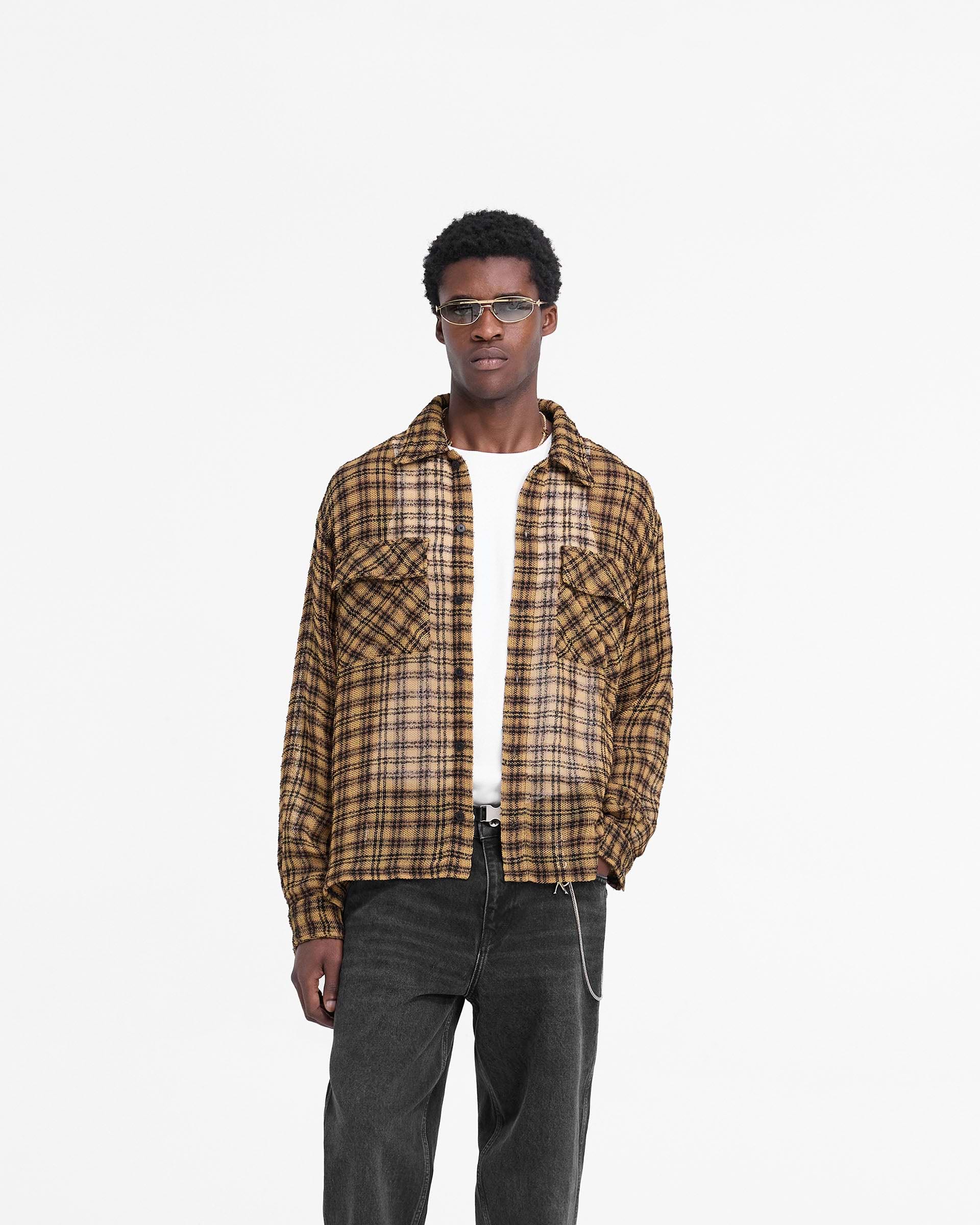 Man wearing a yellow checked flannel shirt on a plain white background | Check Flannel Shirt in Yellow Check | Oversized shirt with flap pockets and button-up front | FW24 Shirts | Represent Clo