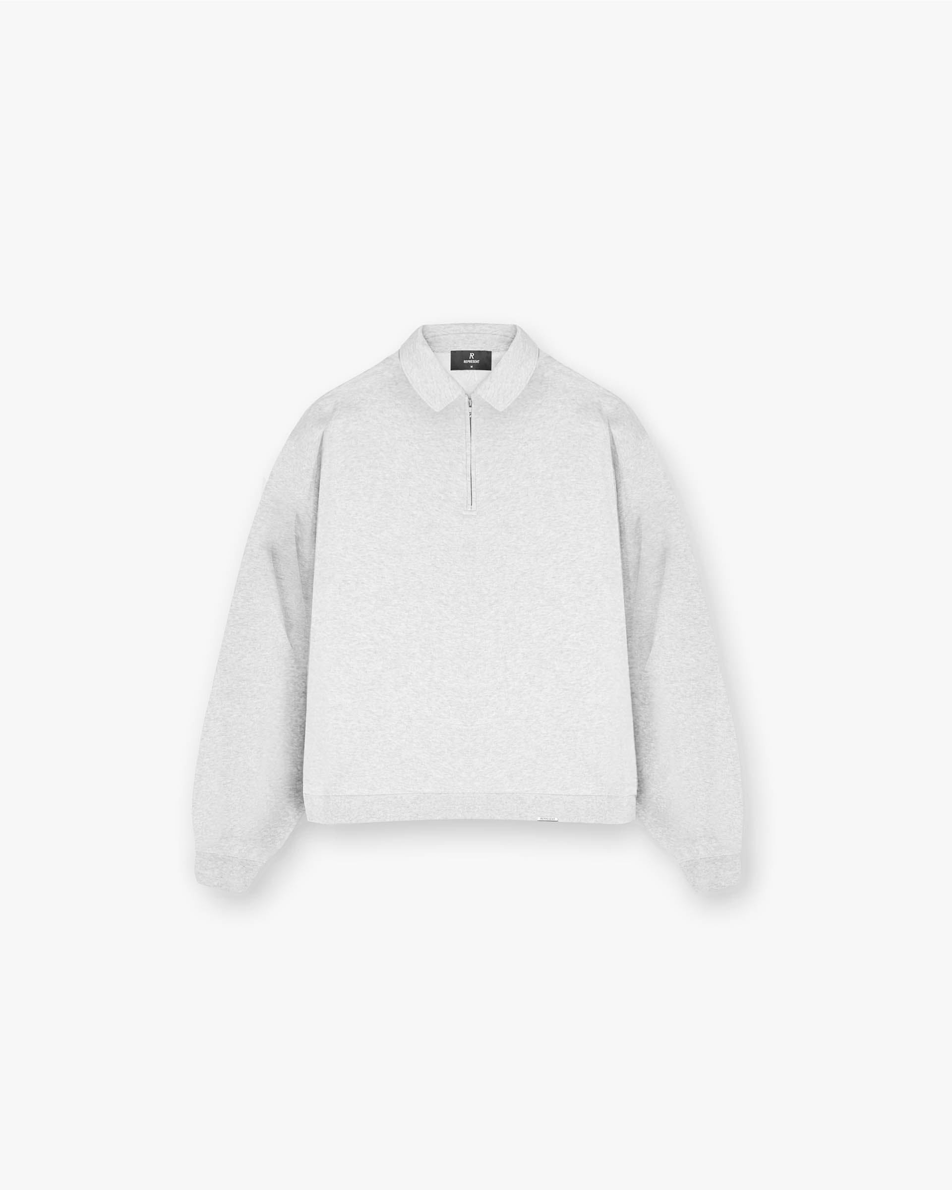 Front product image of a mens grey track jacket on a plain white background | Initial Boxy Quarter Zip in Ice Grey Marl | Track jacket with double ended zip and welt pockets | Initial Sweaters | Represent Clo