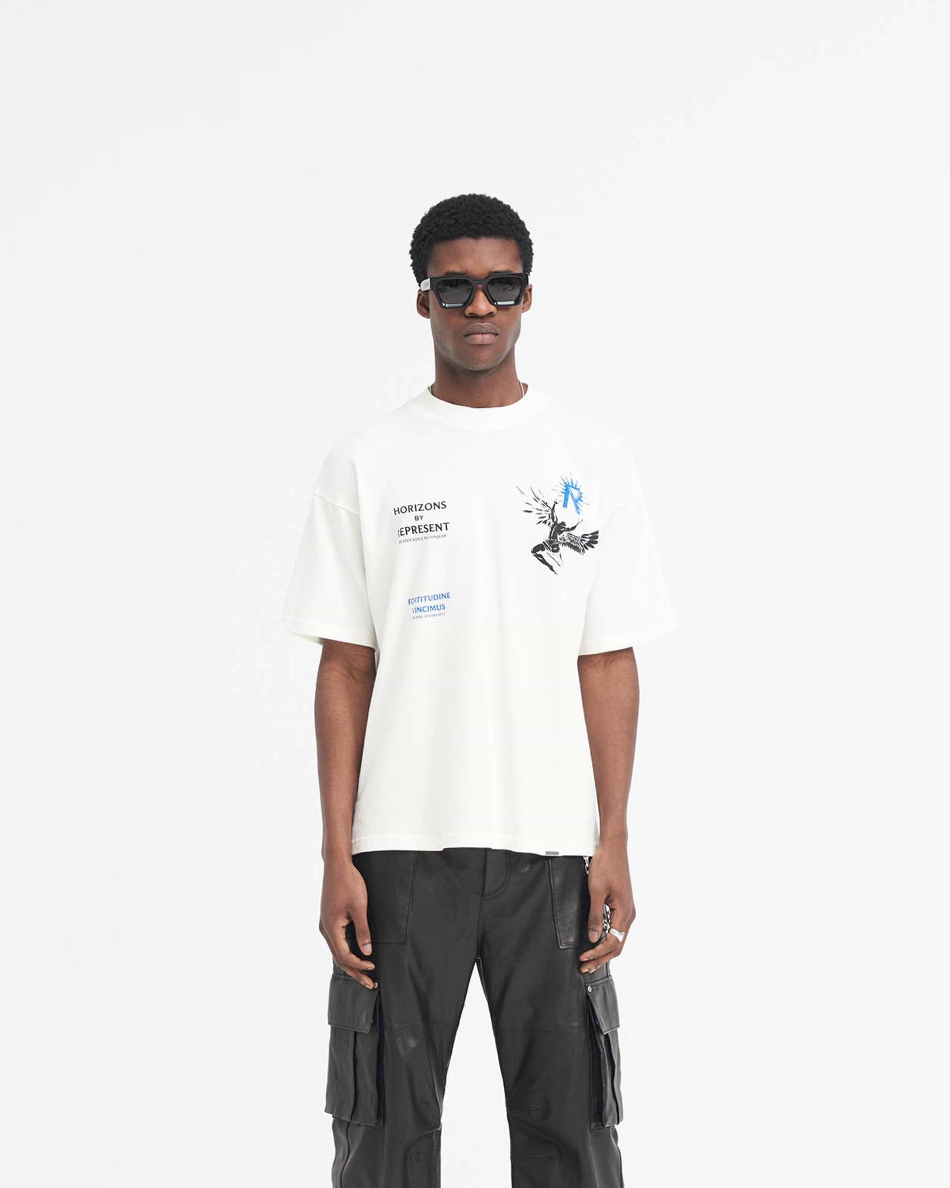 Man wearing a white t-shirt on a plain white background | Icarus T-Shirt in Flat White | Oversized fit t-shirt with Icarus graphic | SS24 T-Shirts | Represent Clo