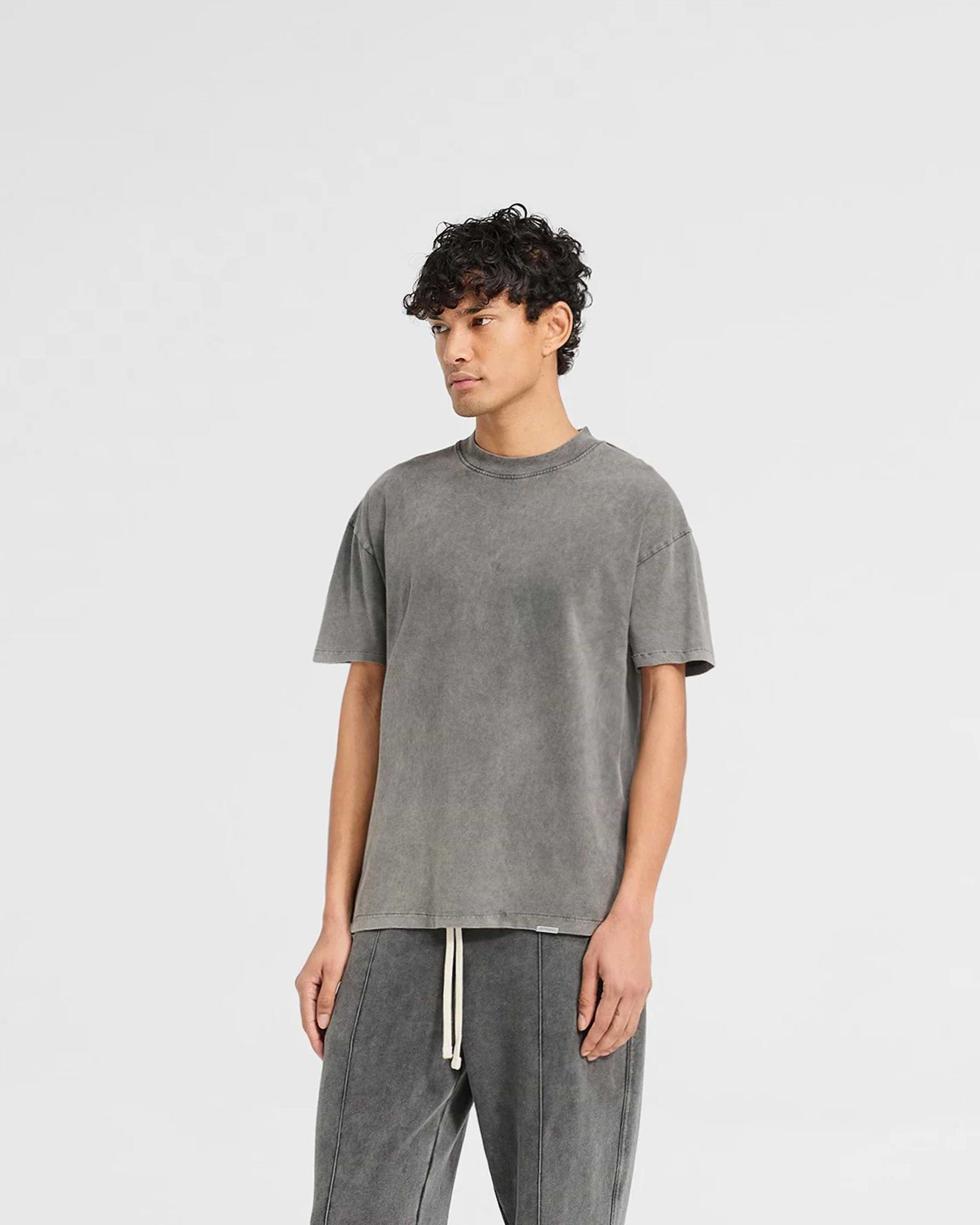 Man wearing a grey t-shirt on a plain white background | Initial T-Shirt in Vintage Grey | Regular fit t-shirt with ribbed collar and embroidered details | Initial T-Shirts | Represent Clo
