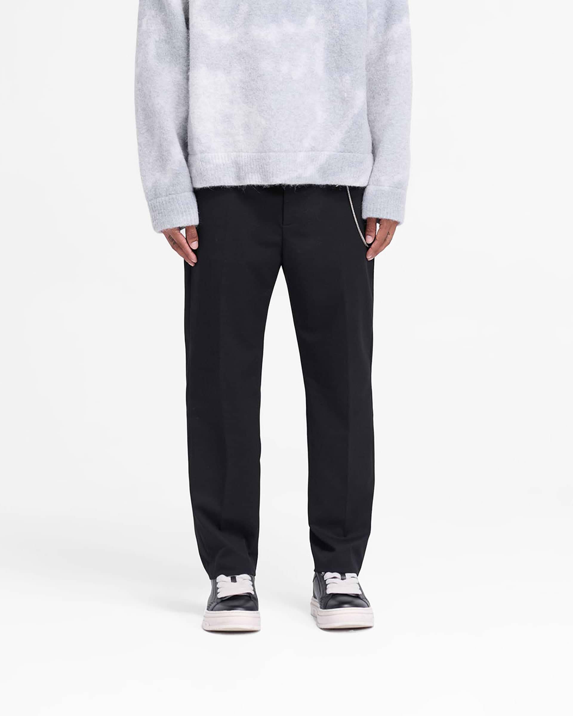 Man wearing black pants on a plain white background | Smoking Pant in Black | Slim silhouette pants with cropped length | FW24 Pants | Represent Clo