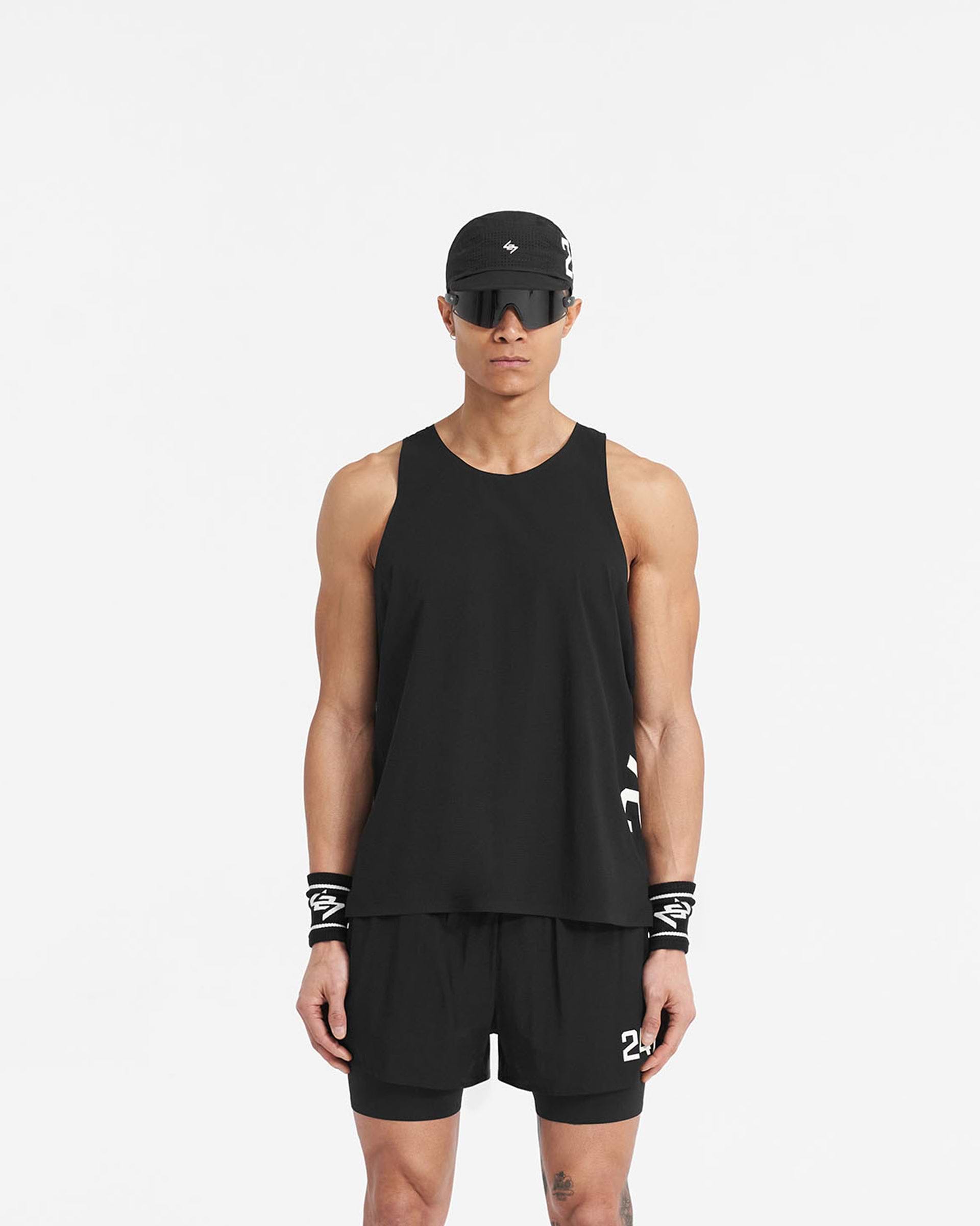 Man wearing a black singlet on a plain white background | 247 Singlet in Jet Black | Perforated training vest with bonded hems and 247 branding | 247 T-Shirts | Represent Clo