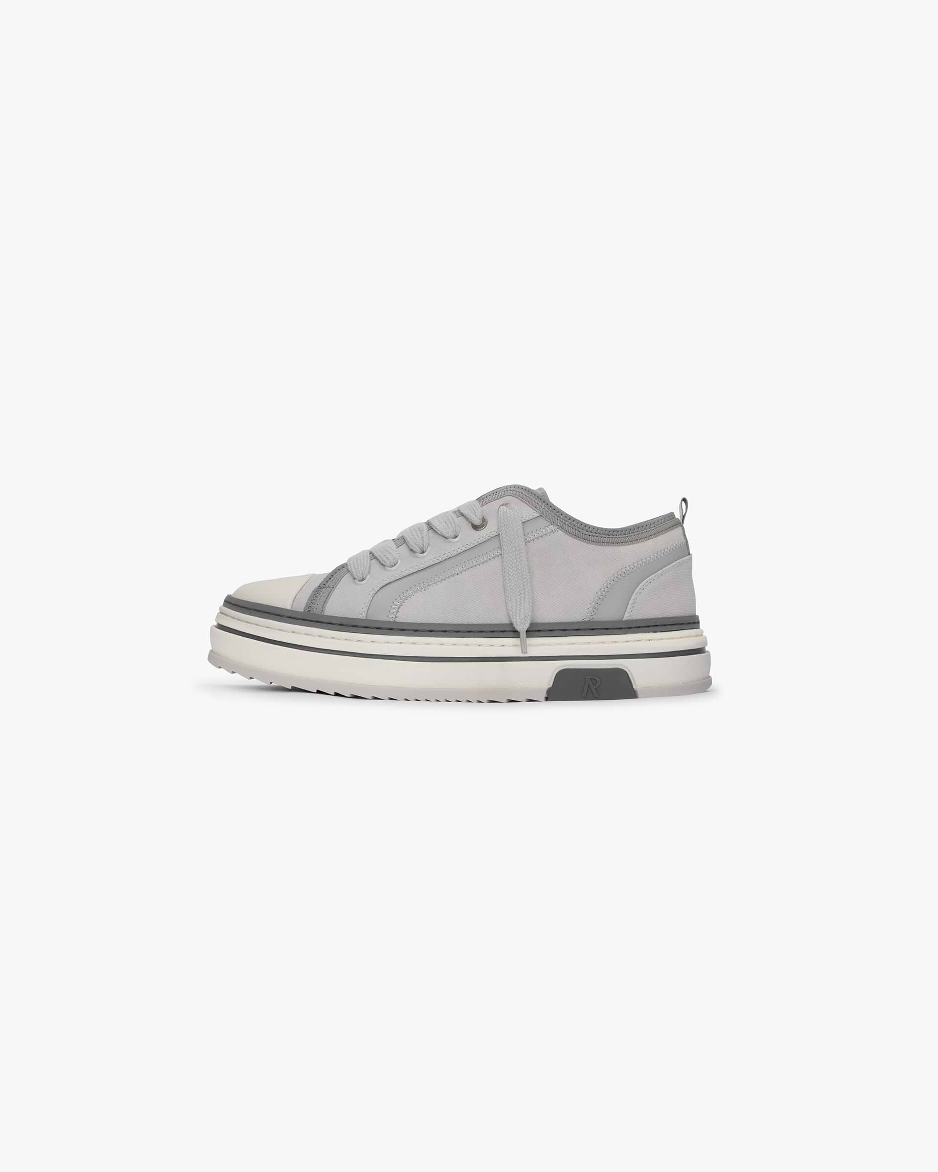 Mens grey sneaker on a plain white background | HTN X Low in Warm Grey | Low top sneaker with canvas upper and chunky rubber outsole | SS24 Footwear | Represent Clo