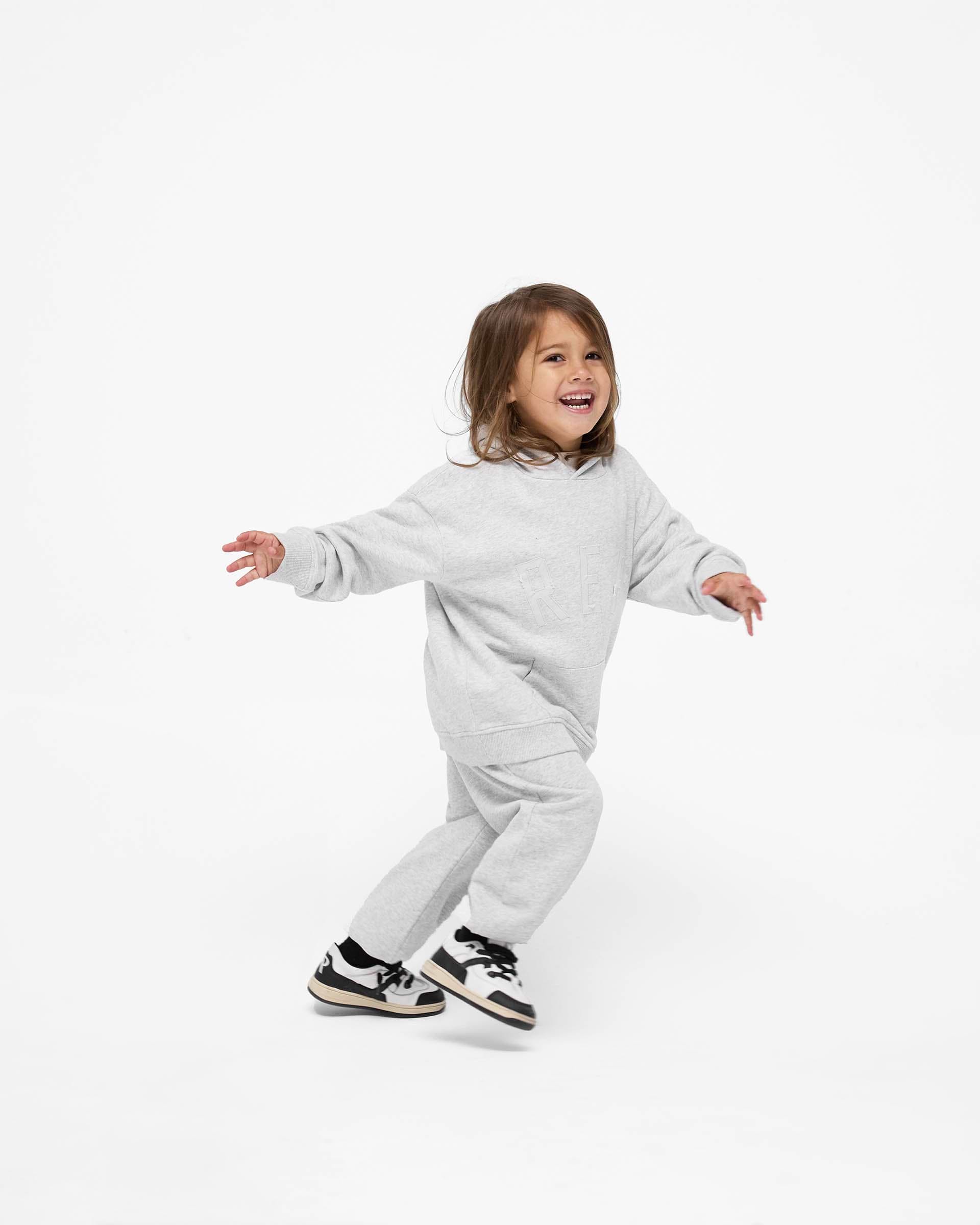 Back product image of kids grey sweatpants on a plain white background | Mini Rep Applique Sweatpants in Grey Marl | Sweatpants with elasticated waistband and cuffs | FW24 Pants | Represent Clo