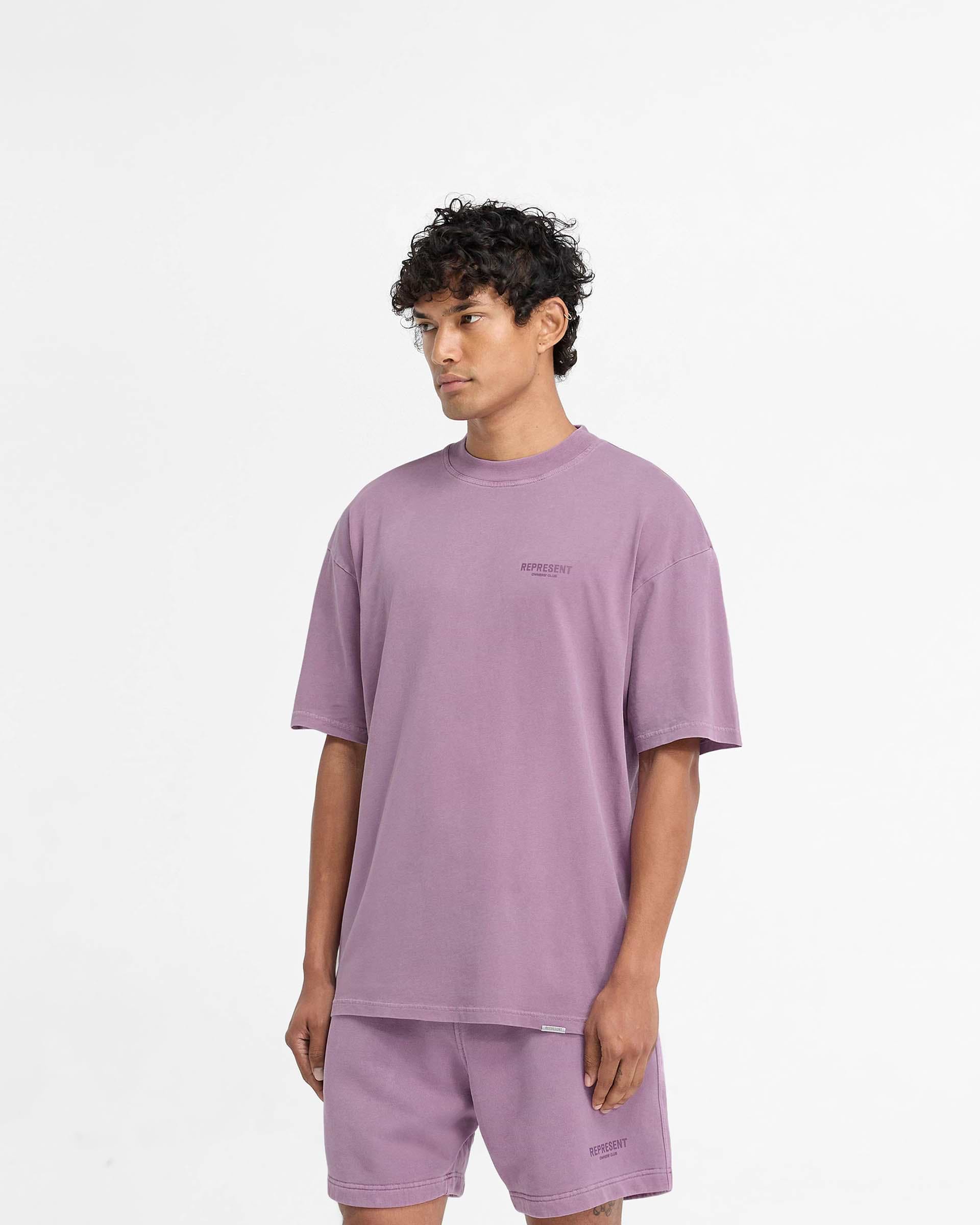 Man wearing an oversized purple t-shirt on a plain white background | Represent Owners Club T-Shirt in Mid Purple | Oversized t-shirt with tonal branding | Owners Club T-Shirts | Represent Clo
