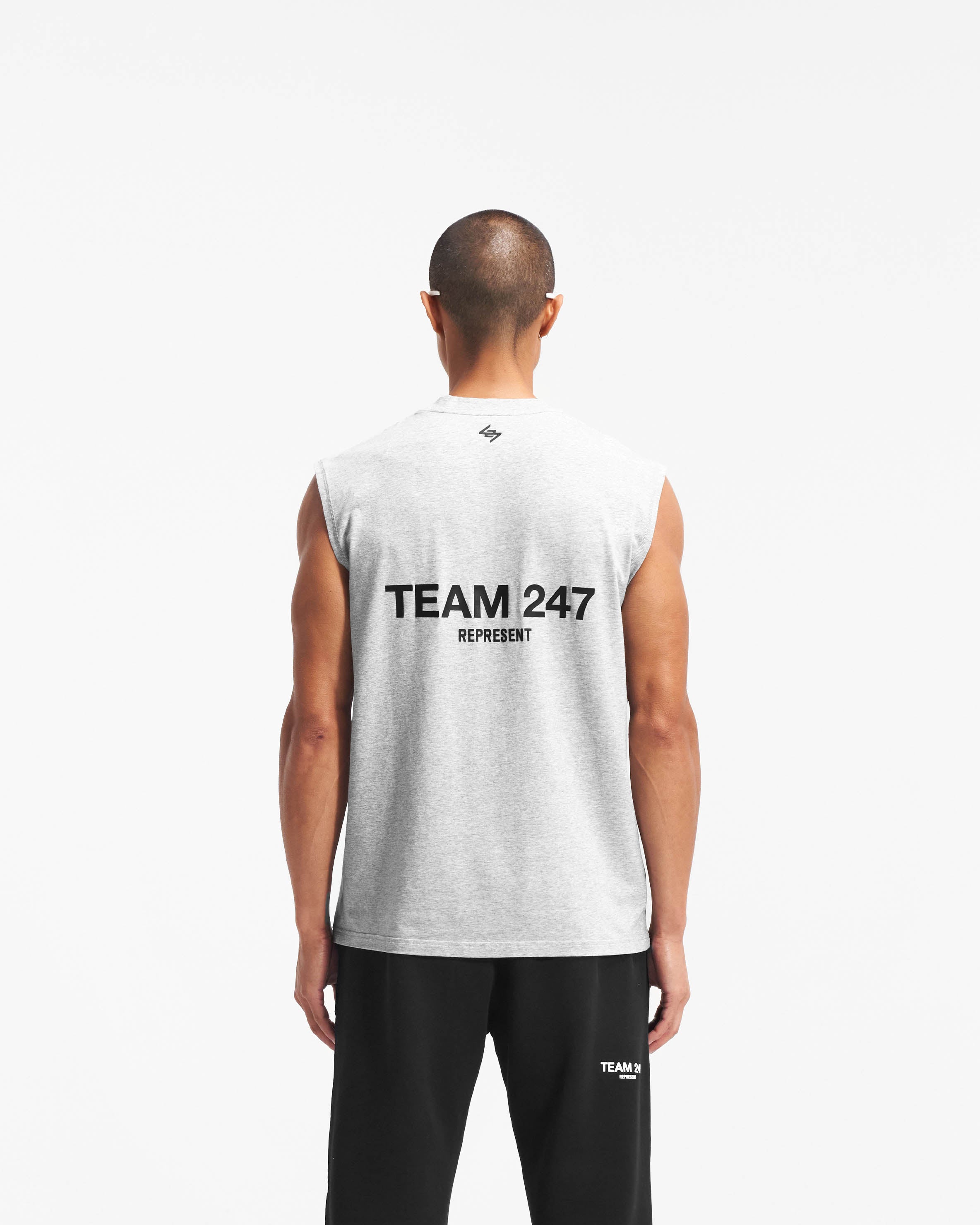 Man wearing an oversized grey tank top on a plain white background | Team 247 Oversized Tank in Ash Grey | Lightweight and breathable tank top with 4-way stretch | 247 T-Shirts | Represent Clo