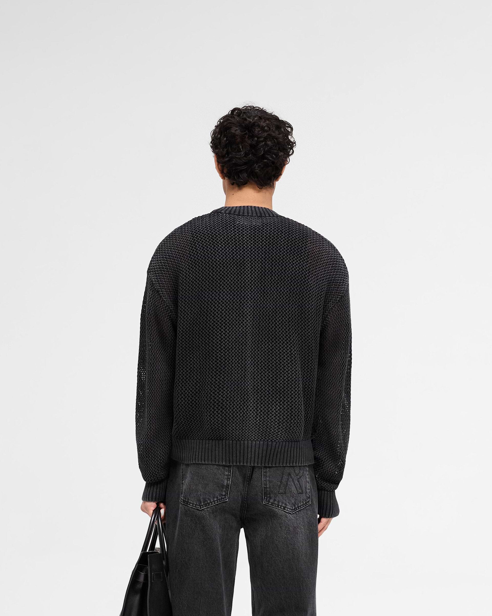 Man wearing a black sweater on a plain white background | Open Gauge Knit Sweater in Jet Black | Oversized knitwear with ribbed trim | SS25 Knitwear | Represent Clo