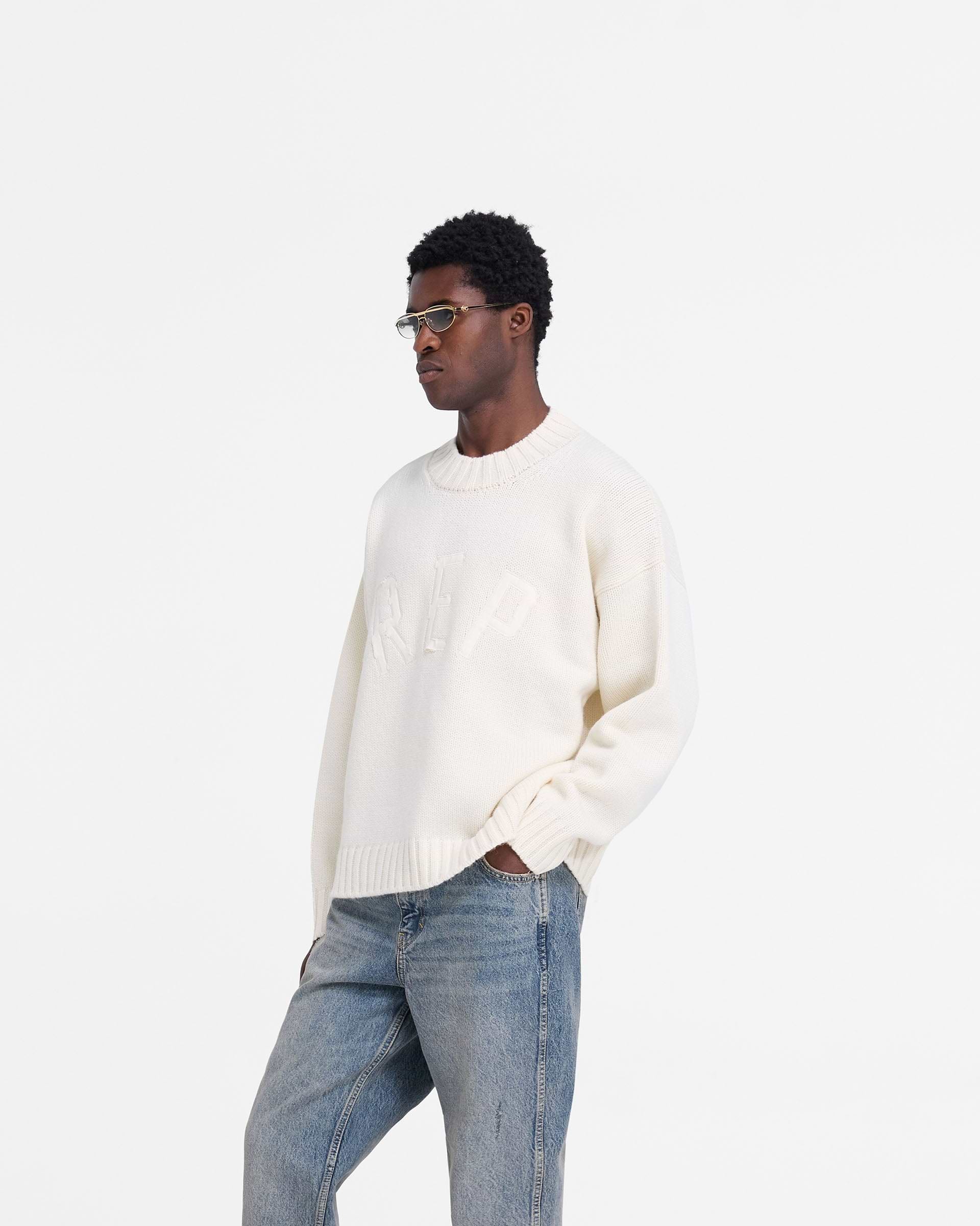 Back product image of a mens oat jumper on a plain white background | Rep Knit Jumper in Oat | Oversized knitwear with ribbed cuffs | FW24 Knitwear | Represent Clo