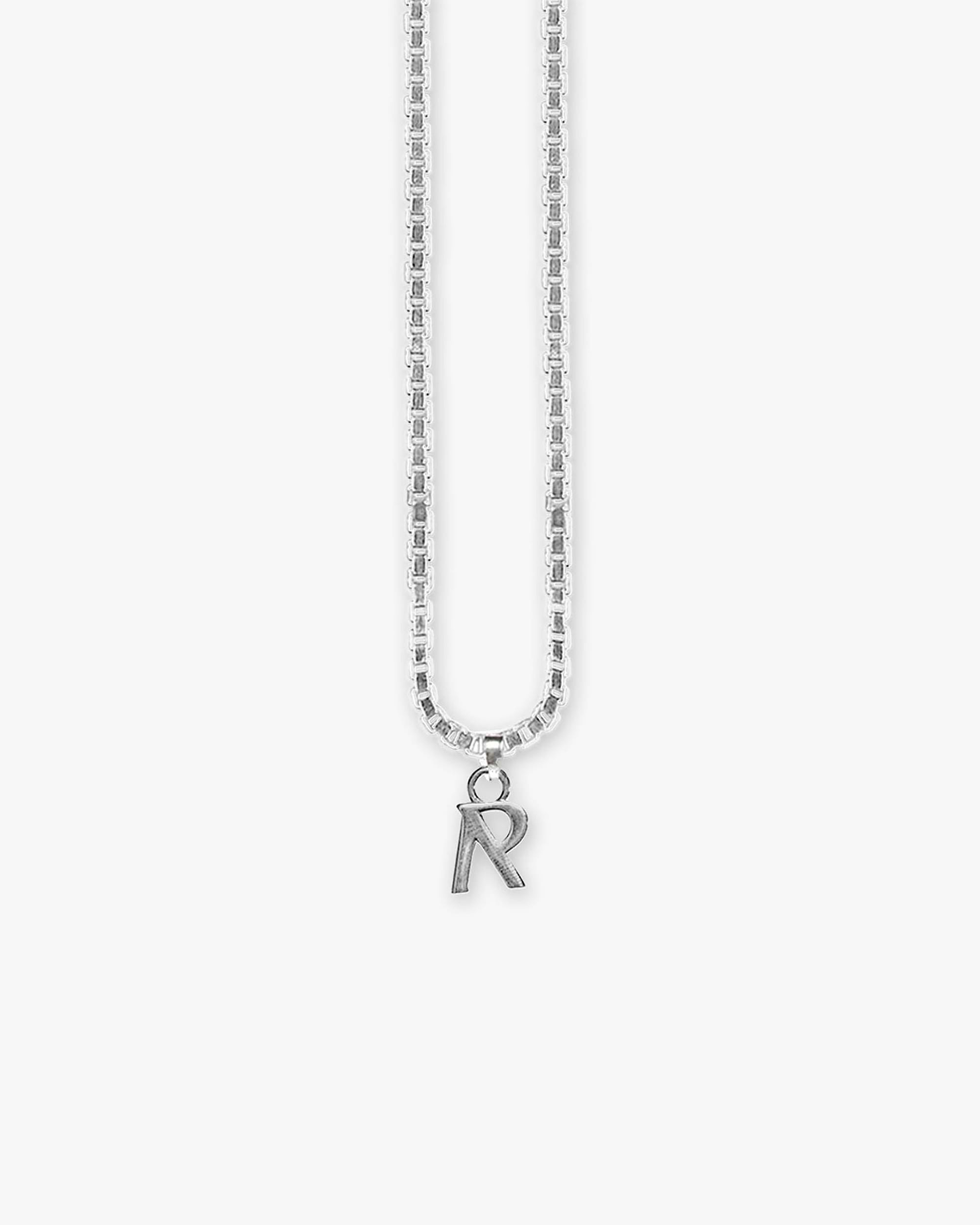 Back product image of a silver pendant on a plain white background | Initial Pendant in Silver | Silver plated brass necklace with box chain | FW22 Accessories | Represent Clo
