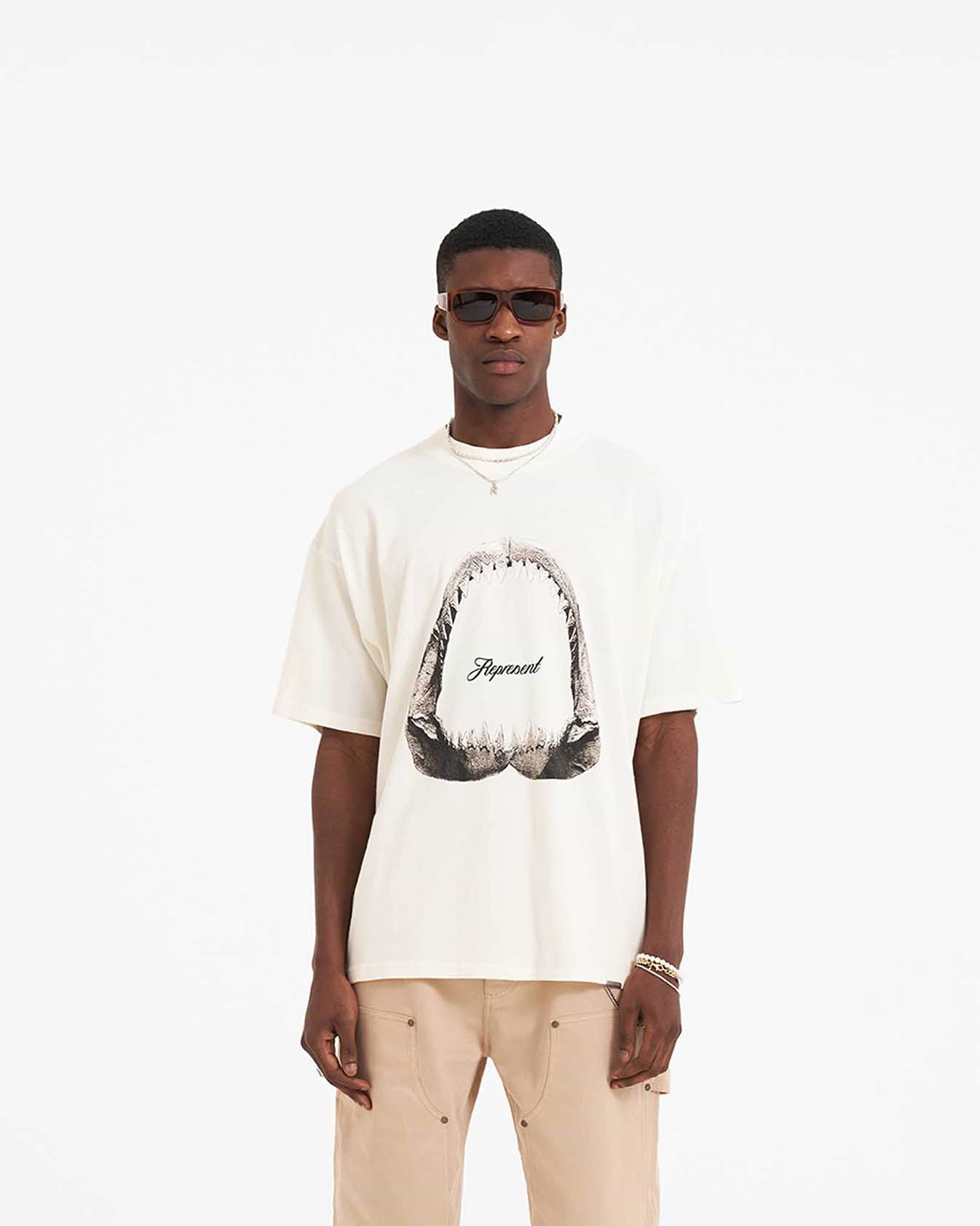 Back product image of a mens white graphic t-shirt on a plain white background | Shark Jaws T-Shirt in Flat White | Oversized short sleeve t-shirt with ribbed crewneck | SS23 T-Shirts | Represent Clo