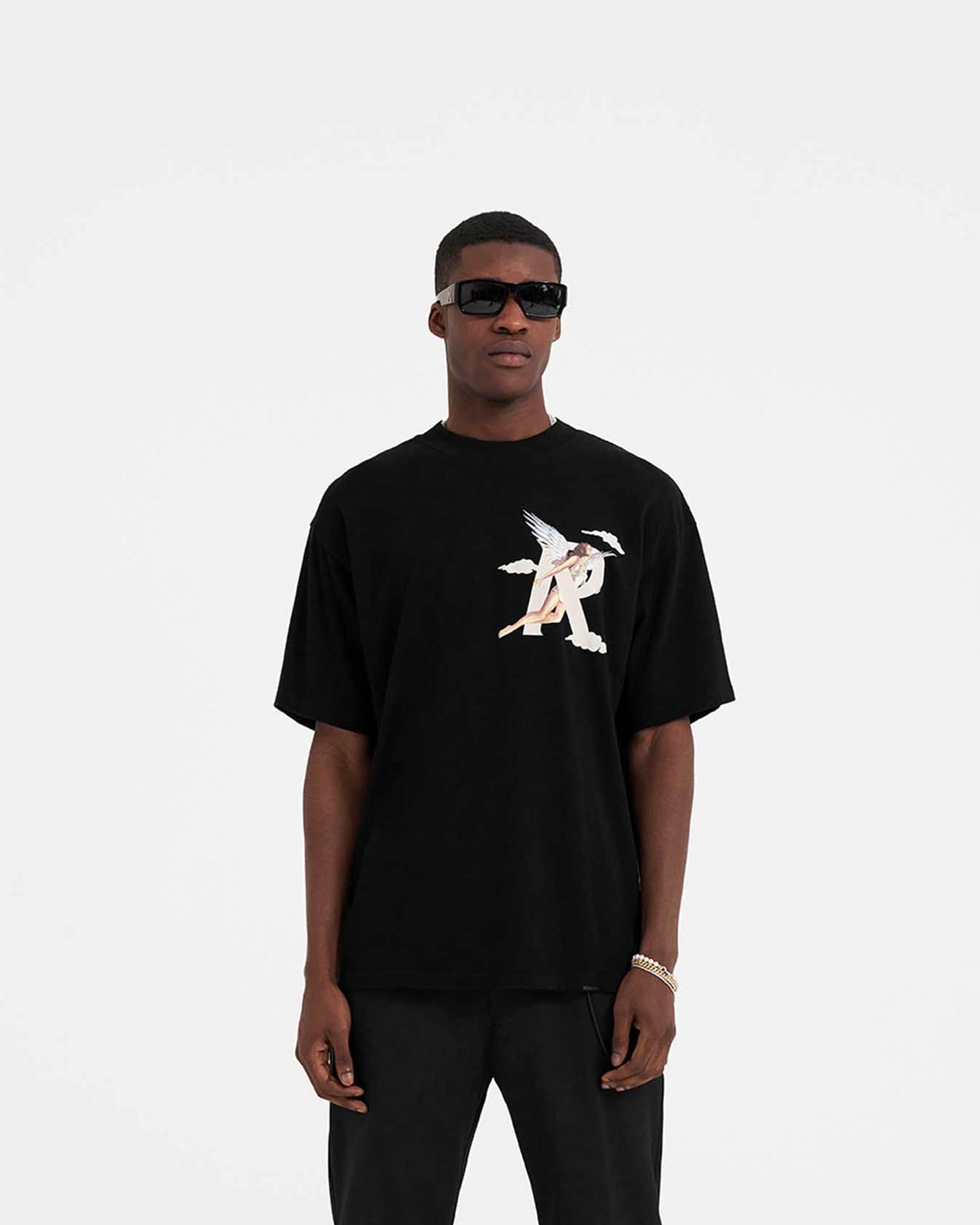 Man wearing a black graphic t-shirt on a plain white background | Storms In Heaven T-Shirt in Black | Oversized fit short sleeve t-shirt with chest and back graphics | SS23 T-Shirts | Represent Clo