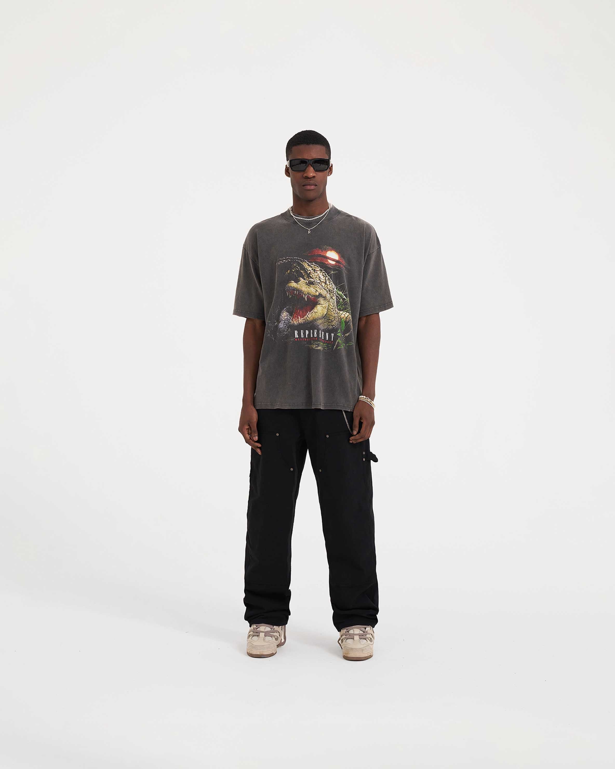 Man wearing a grey t-shirt on a plain white background | Destructive Appetite T-Shirt in Vintage Grey | Graphic t-shirt with ribbed crewneck and oversized fit | SS23 T-Shirts | Represent Clo