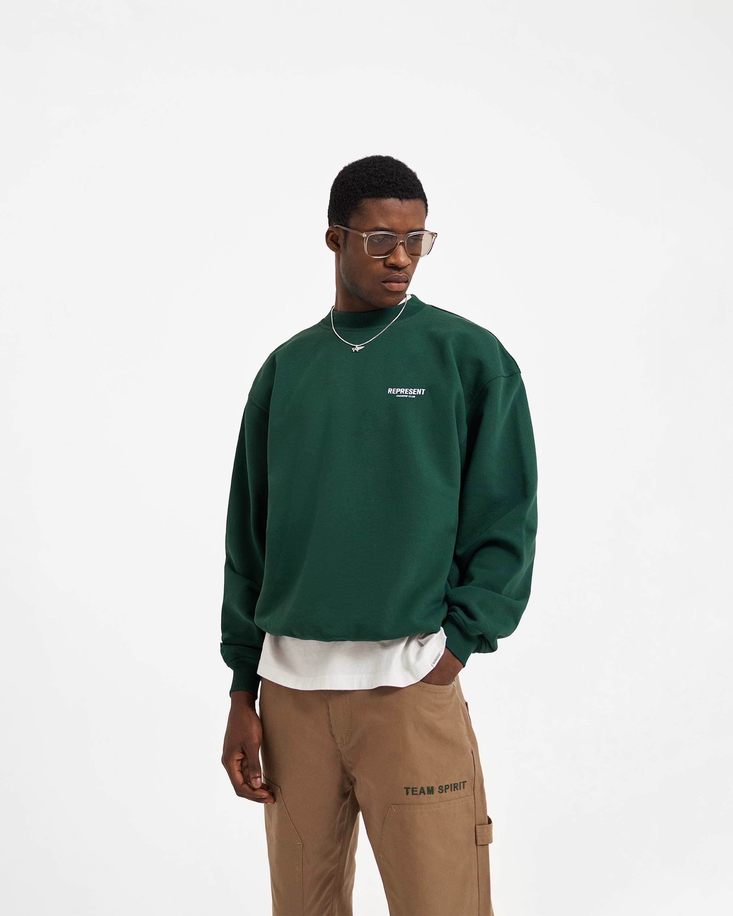 Man wearing a green sweater on a plain white background | Represent Owners Club Sweater in Racing Green | Heavyweight oversized cotton sweater with ribbed trims | Owners Club Sweaters | Represent Clo