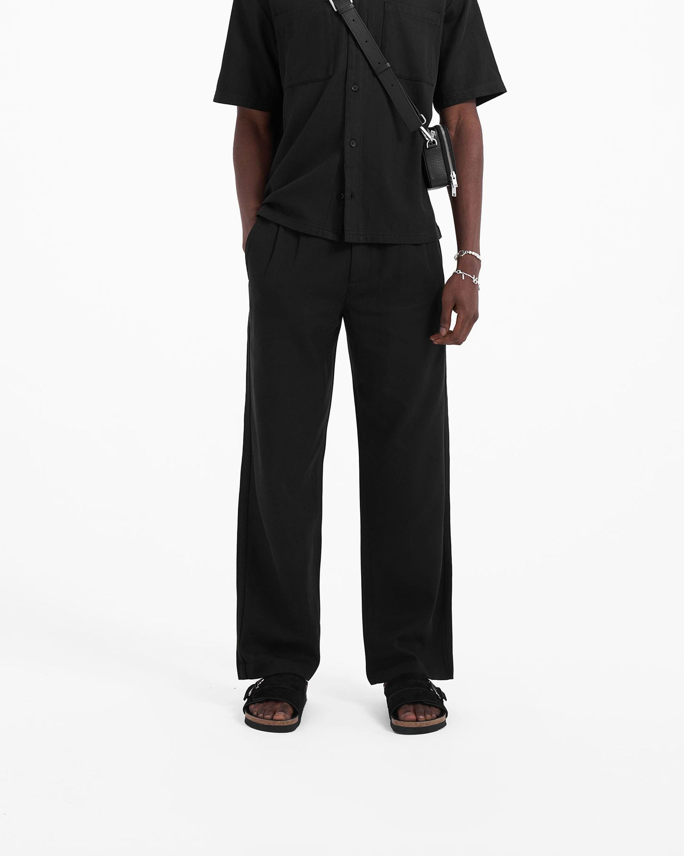 Back product image of mens black pants on a plain white background | Yacht Pant in Black | Relaxed fit pants with hybrid elasticated waistband | SC23 Pants | Represent Clo