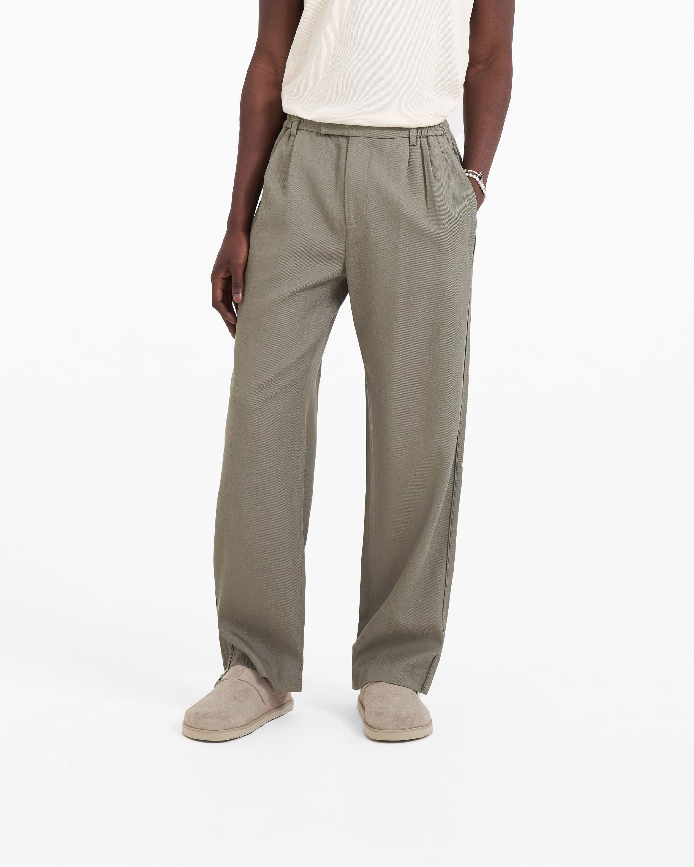 Back product image of mens khaki pants on a plain white background | Yacht Pant in Khaki | Relaxed fit pants with hybrid elasticated waistband | SC23 Pants | Represent Clo
